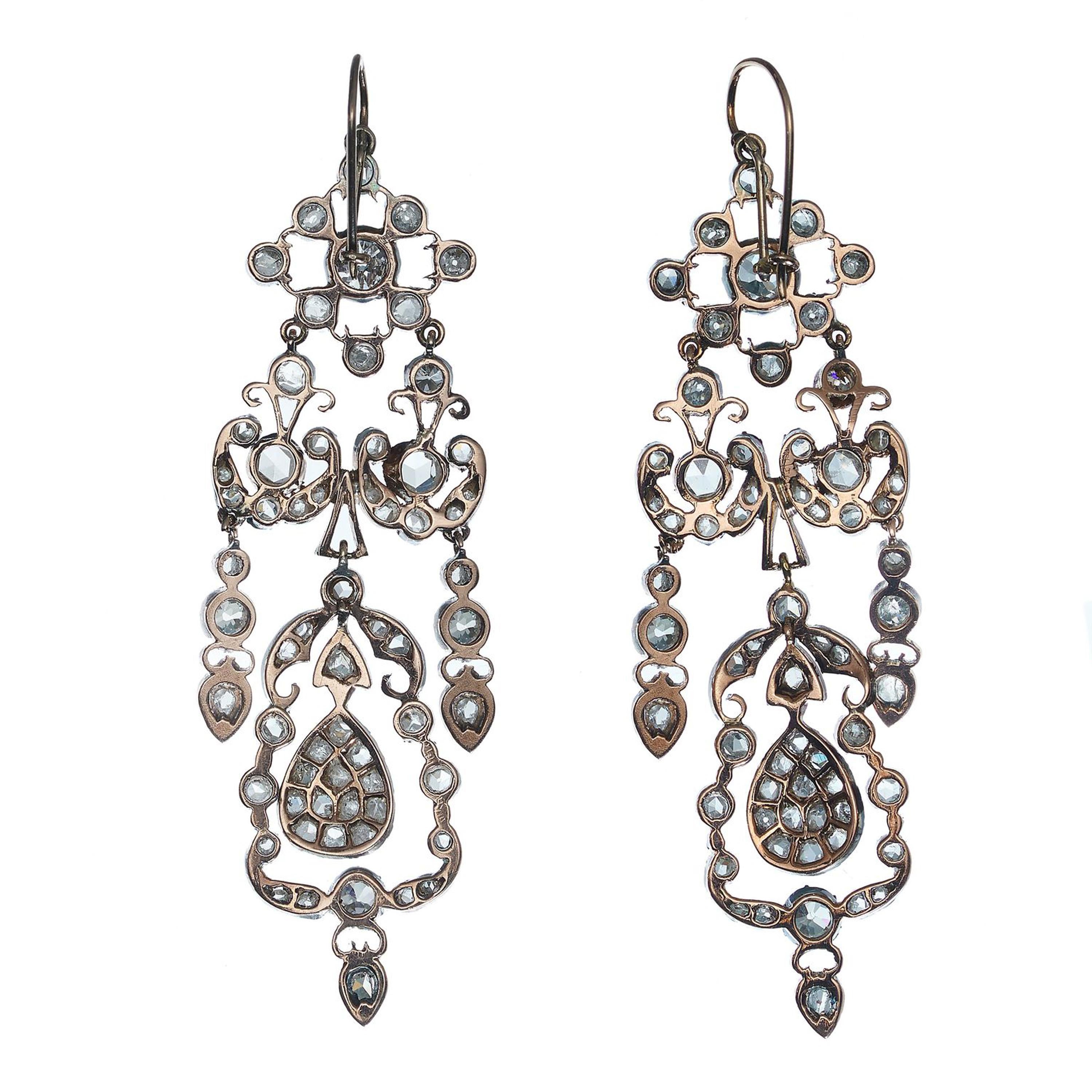 A pair of antique style, diamond set, drop-shape earrings, with a lattice cluster at the top, with an old-cut diamond in the centre, with surrounding rose-cut diamonds and old mine-cut diamonds, set upside down, with a double garland below, set with