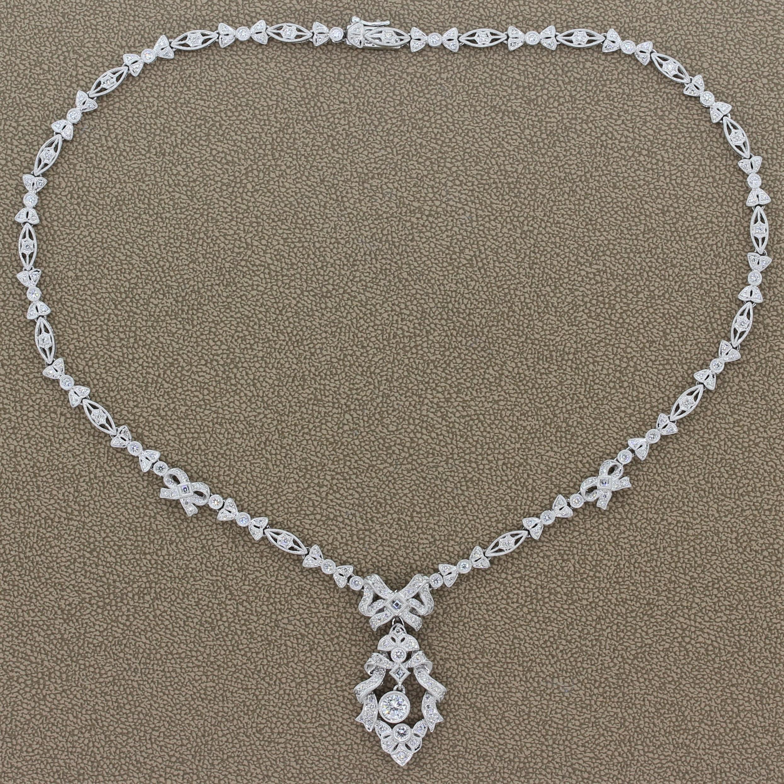 A feminine necklace made in Edwardian style featuring a 0.54 carat round cut diamond drop. The ribbons and bows of this platinum necklace are studded with 3.82 carats of round cut diamonds with a milgrain border. The detachable drop has a hook so