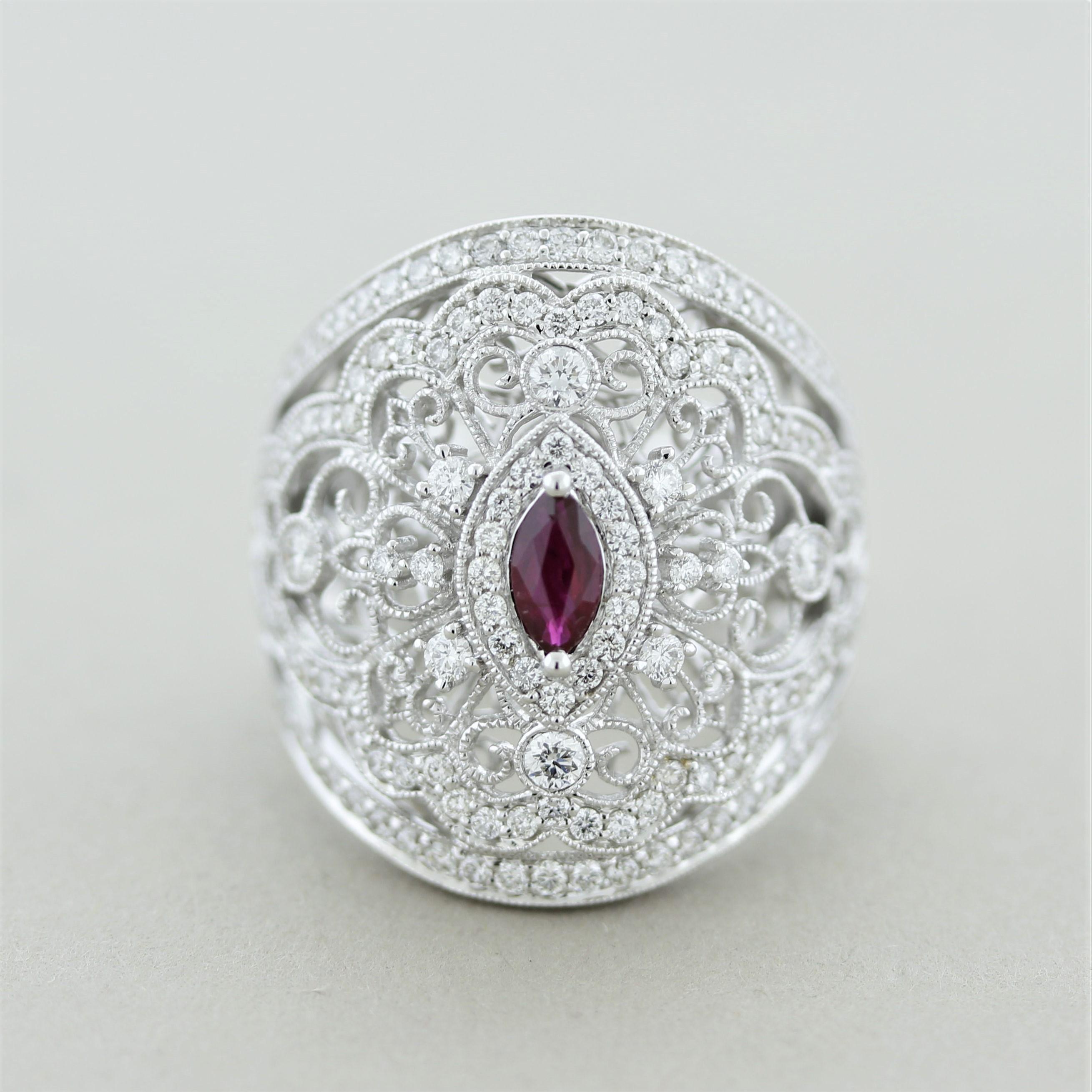 A classy ring made in the antique style with Edwardian era themes. The center ruby is a 0.26 carat marquise with a vivid red color. It is accented by 1.13 carats of round brilliant-cut diamonds. Adding to that, there is fine gold filigree work