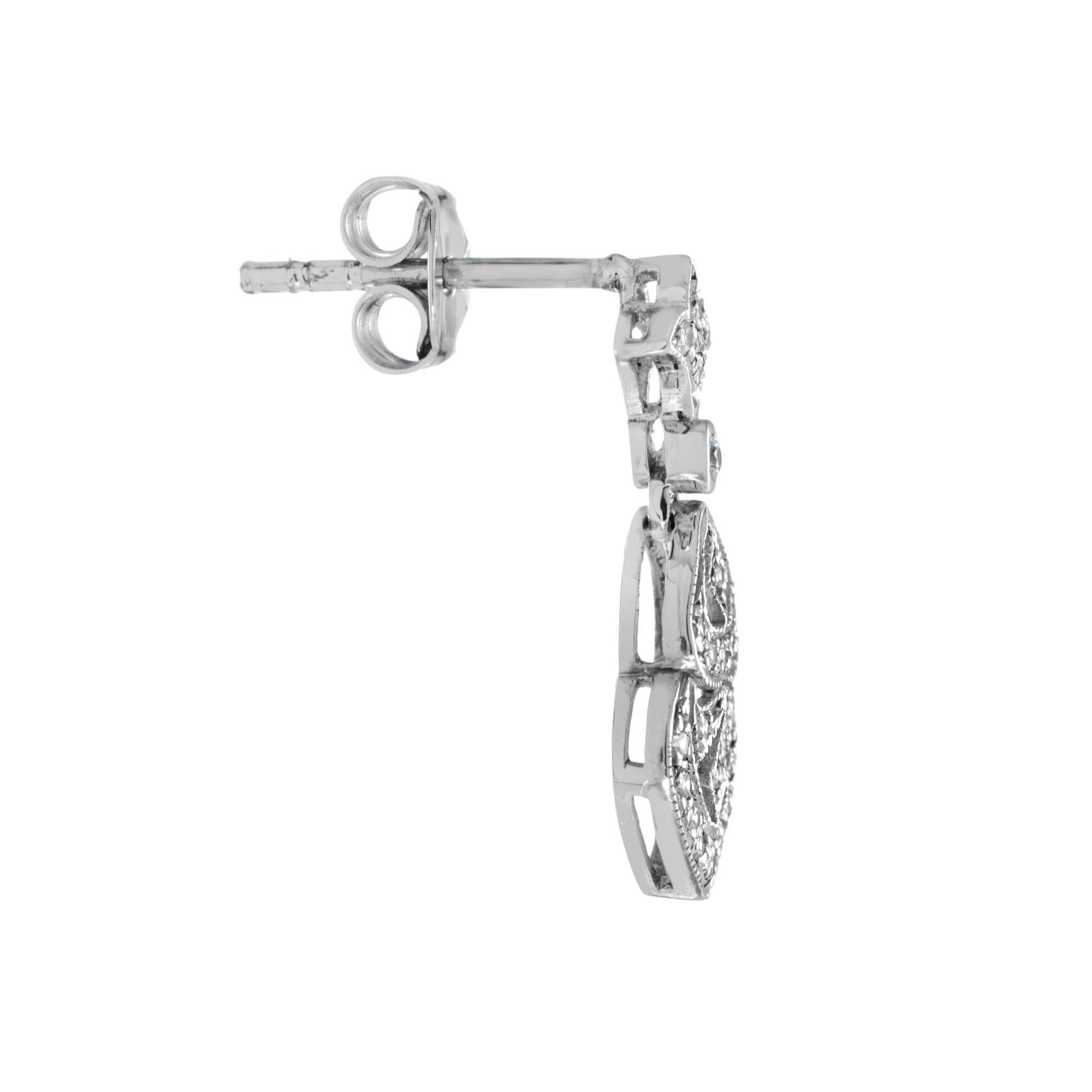 Antique drop diamond earrings, with fine vintage-inspired detailing, radiant glamor and sophistication. Brilliant round diamonds totaling 0.25 carat weight (approx.) are held in a gold setting. These stunners are perfect for any occasion. They also
