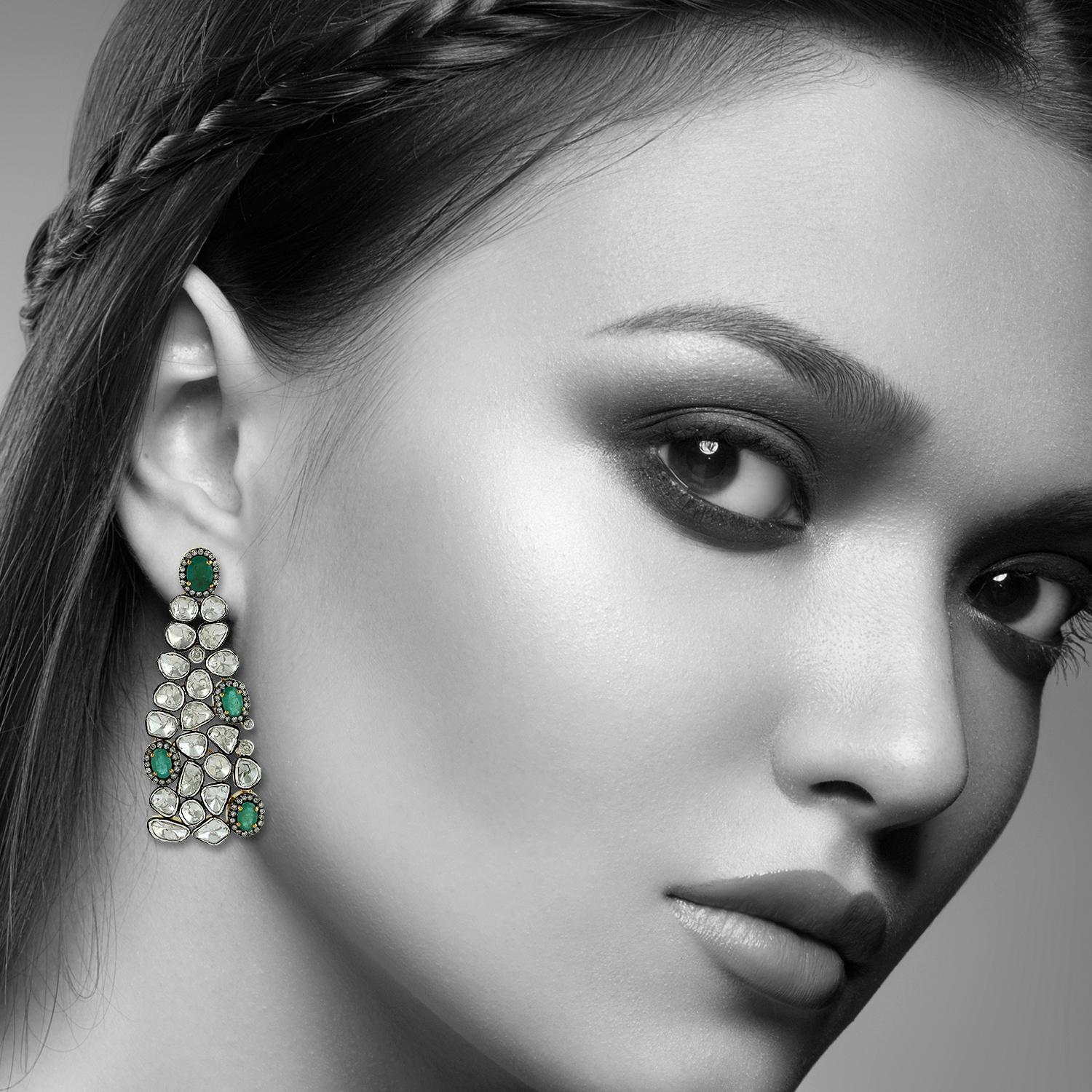 These stunning earrings are handcrafted in 18-karat gold & sterling silver.  They have a chandelier-style silhouette that's encrusted with 4.0 carats emeralds and 12.05 carats of rose cut diamonds with blackened finish.

FOLLOW  MEGHNA JEWELS