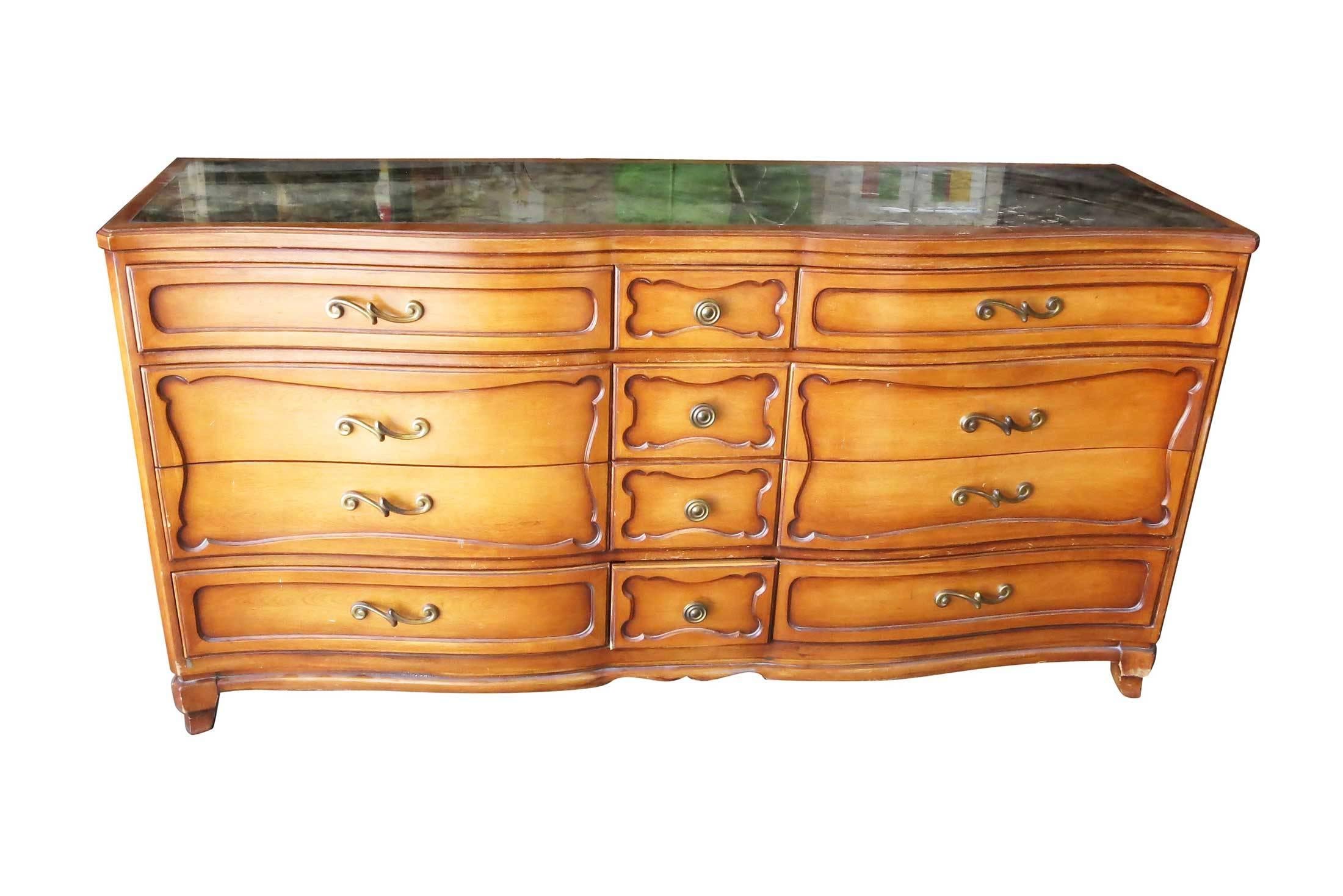 Beautiful dresser console by reputable RWAY furniture featuring a mercury glass mirrored glass top with bronze pulls and twelve drawers. 

Solid wood and in good vintage condition for its age. The dresser shows surface wear from age/use, along