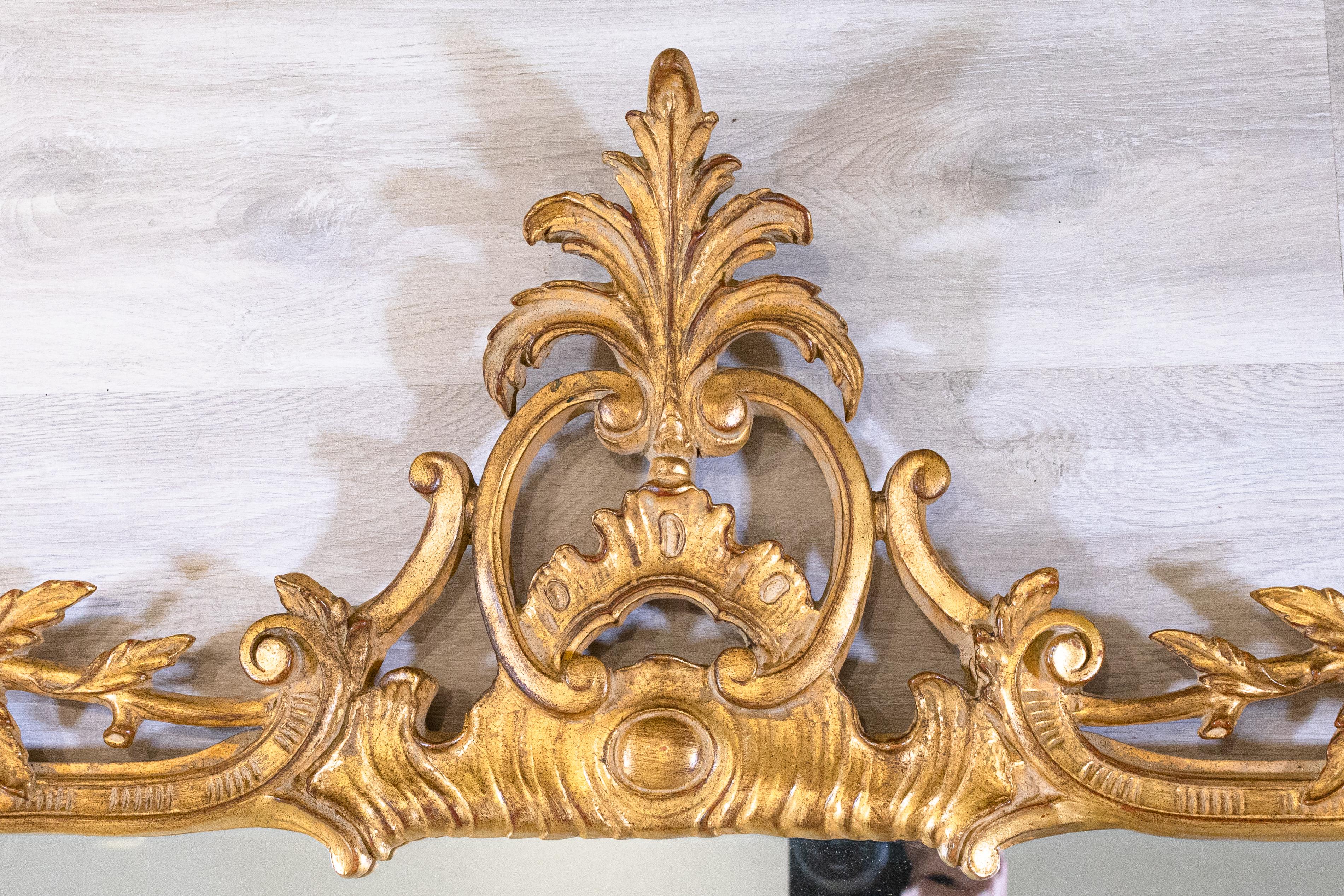 A grand antique style La Barge gold gilt chippendale style mirror. This horizontal mirror measures 46.25 in tall, 60 in wide, and 3.5 in thick. This mirror is very heavy and requires heavy duty wiring or screws with anchoring. This piece is in very
