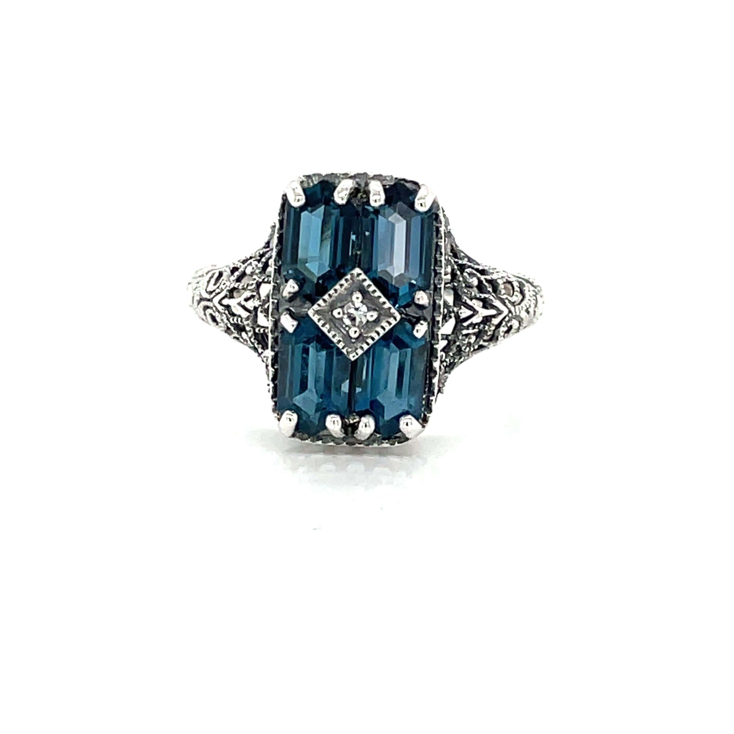 Four faceted hexegon shaped beautiful London Blue Topaz grace the front of this antique style .925 sterling silver ring.
In size 7. New and presented in a miniature antique style gift box.  