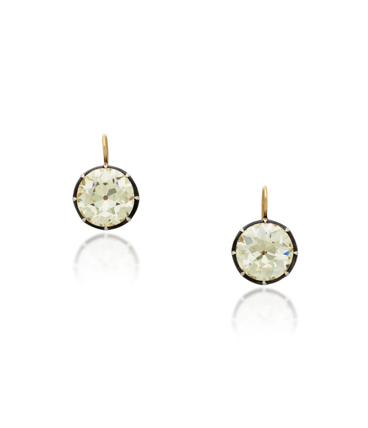 Simply gorgeous! 
These incredible antique style old European cut diamond dangle earrings are beautifully hand made in silver and yellow gold. 
The details are as follows : 
Old European cut diamond weight : 10.10 carats and 10.06 carats ( total of