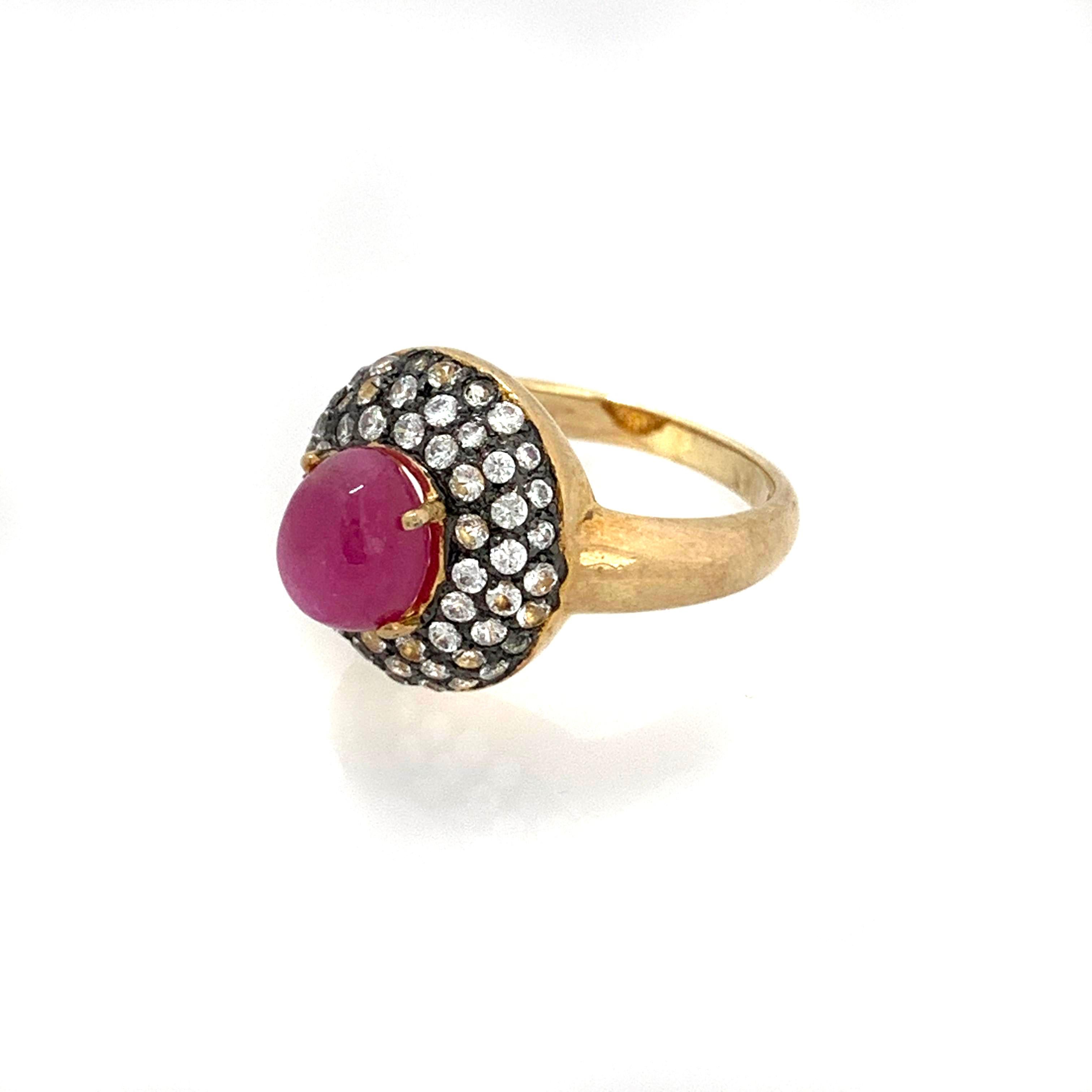 Antique-style Oval Ruby and White Topaz Bombe Cocktail Ring

This fabulous ring features a 4ct pink-ish oval cabochon-cut Mozambique ruby surrounded with 51pcs of round white topaz, handset in two-tone 18k gold vermeil and black rhodium gilded over