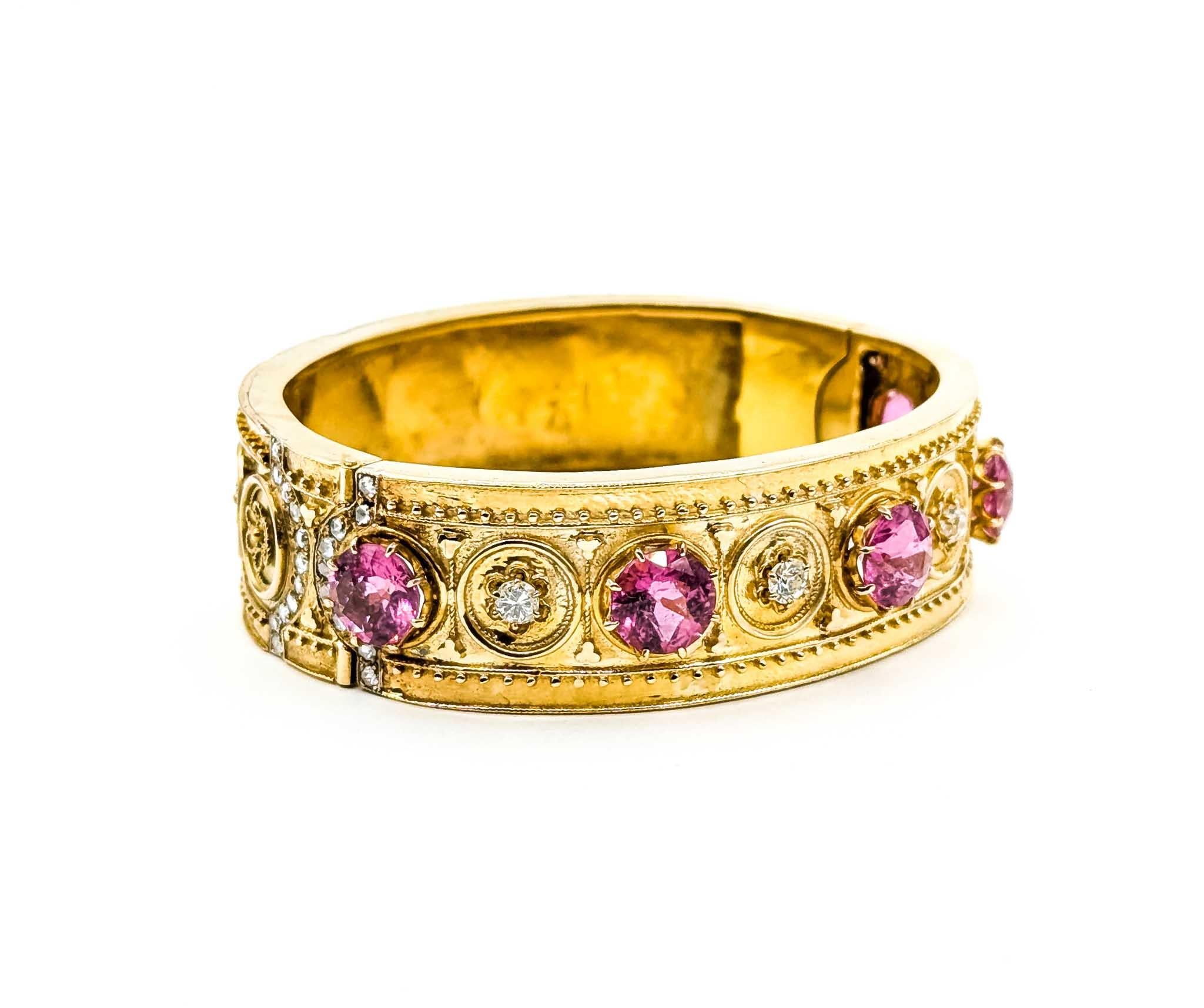 This exquisite bracelet showcases the harmonious blend of vibrant pink tourmaline and sparkling diamonds, artfully set in a 14k yellow gold bangle with an antique style. The bracelet features an impressive 8.0 carats of pink tourmaline, which