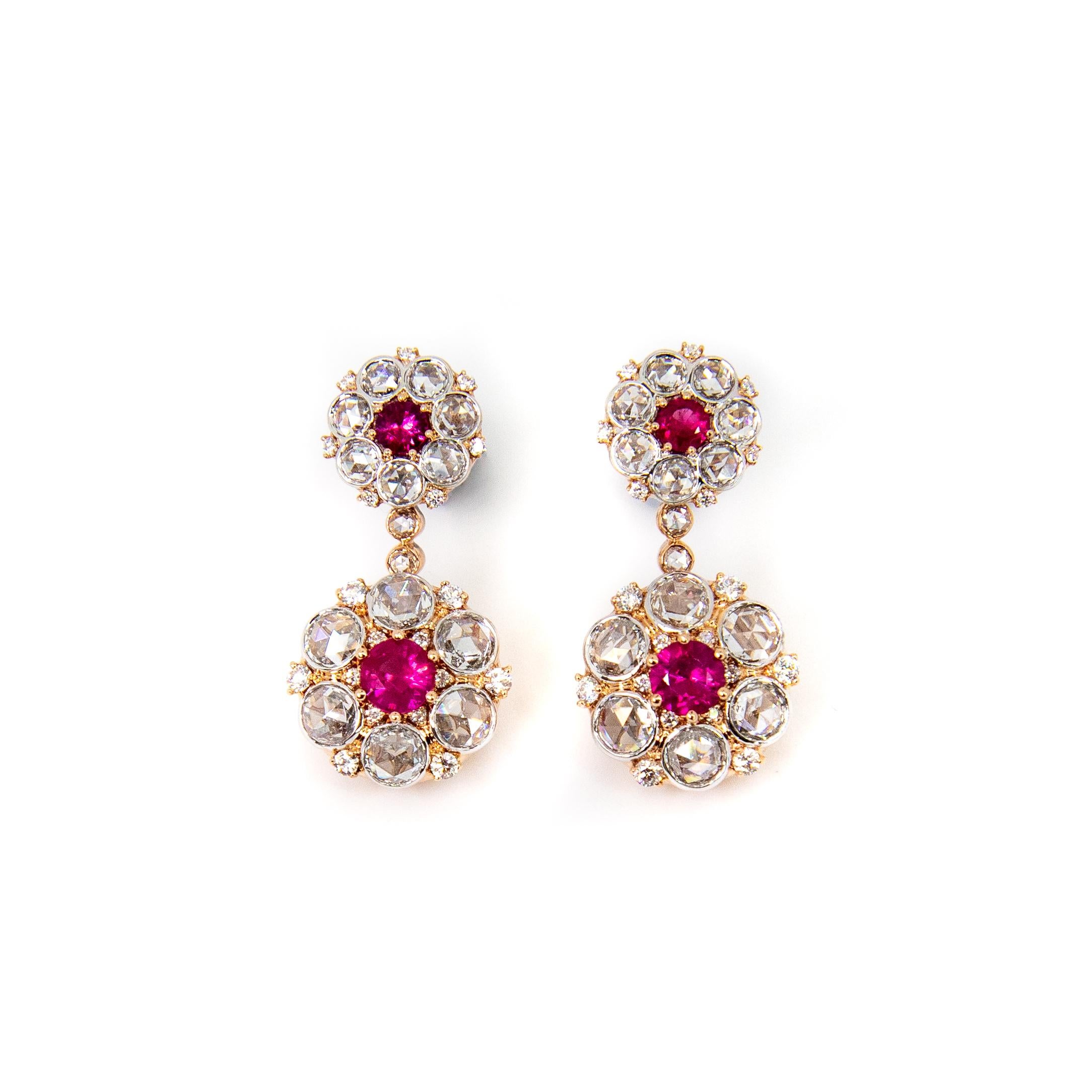 Beautiful ruby and rose cut diamond earrings with ornate gallery setting.

1.03ct lively round Ruby with a vivid pink colour. 
2.41ct Rose Cut Round Diamonds, G colour and VS clarity. 
0.29ct Round Brilliant Diamonds, G colour and VS clarity.

Set