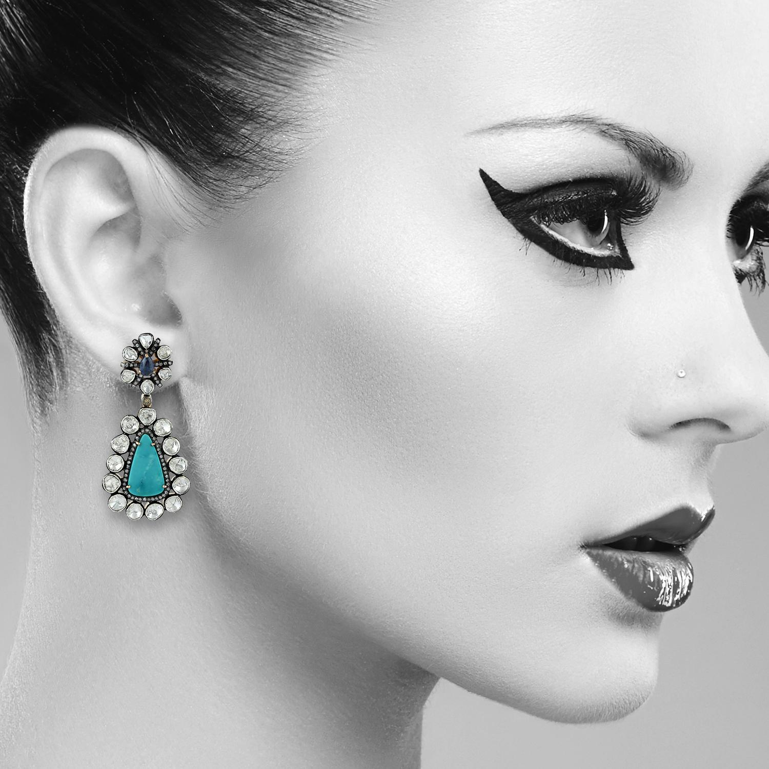 Cast from 18K gold and sterling silver,  these beautiful earrings are set with 7.3 carats turquoise, 1.15 carats sapphire and 7.37 carats rose cut diamonds with blackened finish.

FOLLOW  MEGHNA JEWELS storefront to view the latest collection &
