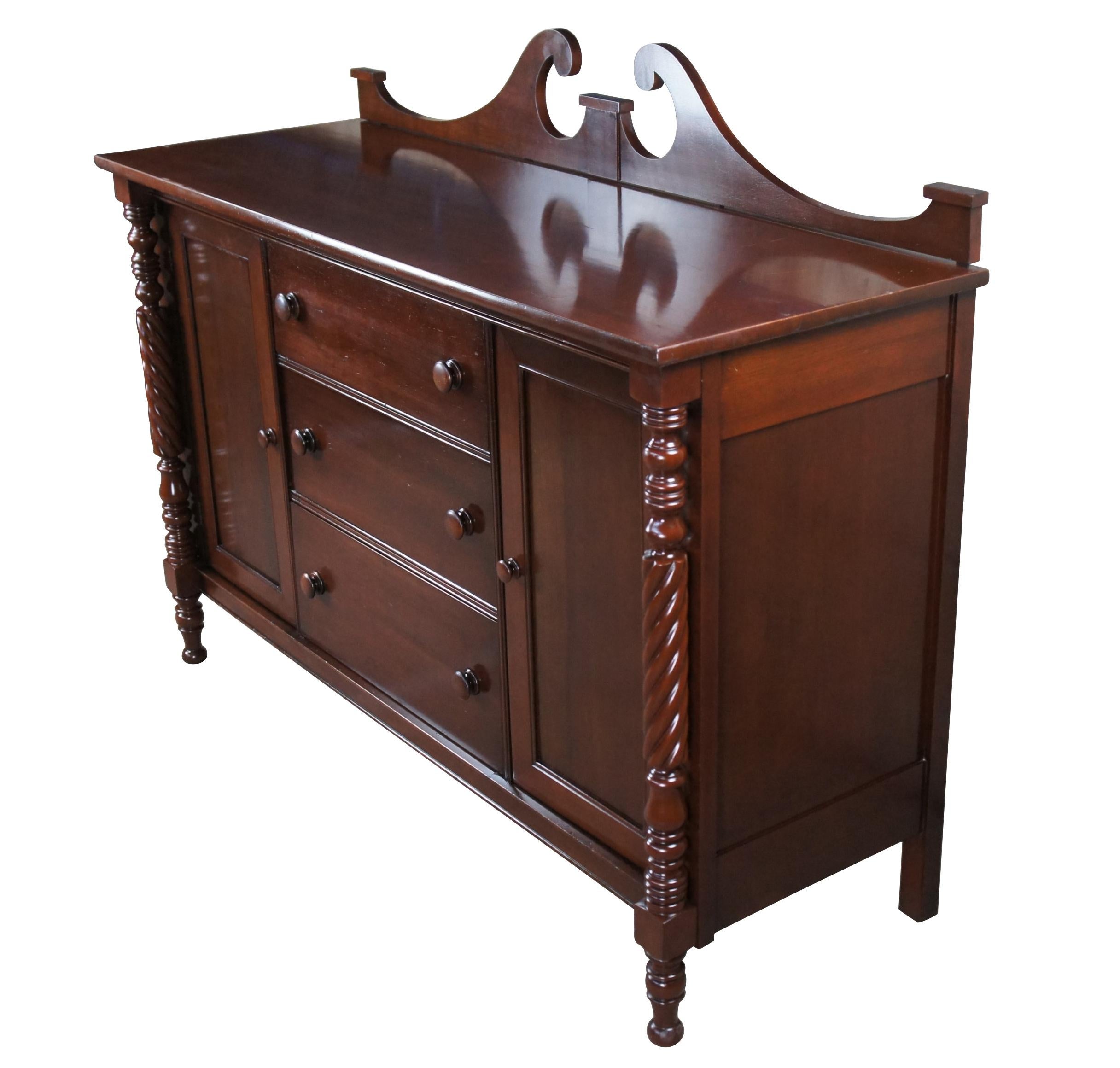 Antique Styled by Park buffet, sideboard or credenza.  Made of cherry featuring Empire styling with open pediment backsplash, barley twisted supports, three drawers, and two cabinets.  Glass top included.

Park, Authetic American Reproductions,