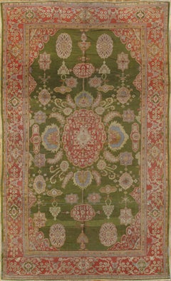 Tapis persan ancien Sultanabad vert, rouge corail, bleu clair, or et ivoire