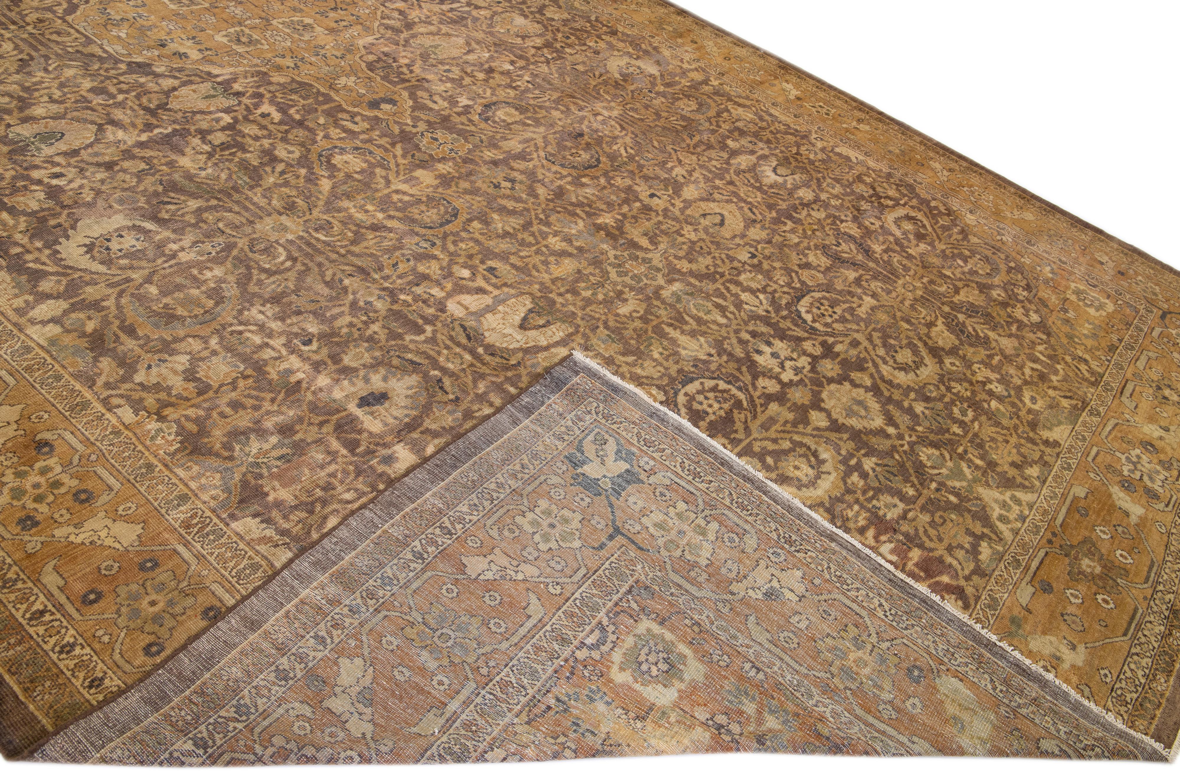 Beautiful antique Persian Sultanabad hand-knotted wool rug with a brown field. This piece has gray and tan accents in a gorgeous all-over floral pattern design.

This rug measures: 12'9