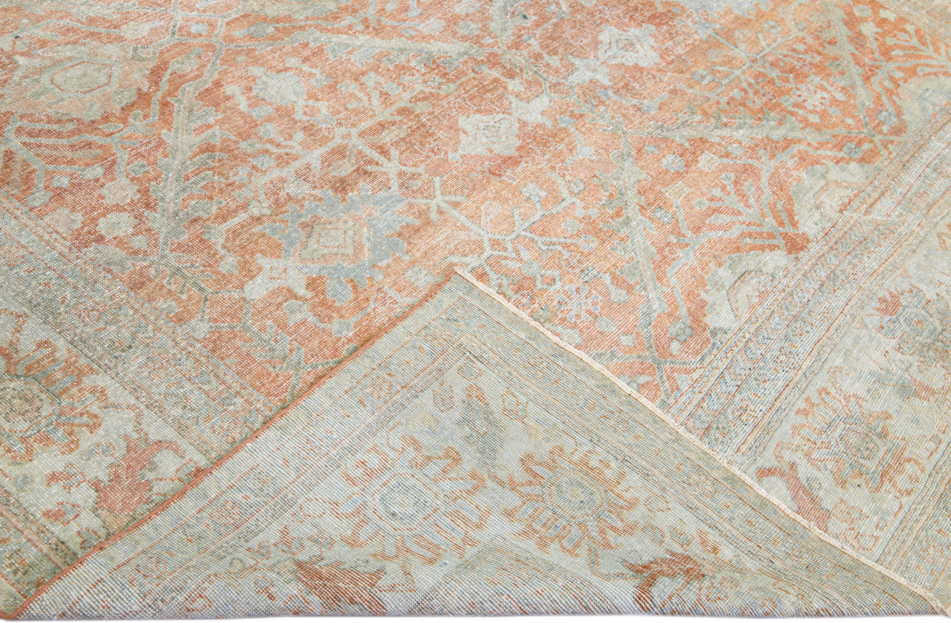 Beautiful antique Persian Sultanabad hand-knotted wool rug with an orange field. This piece has a light blue designed frame and gray accents in a gorgeous all-over floral pattern design.

This rug measures: 9' x 12'8