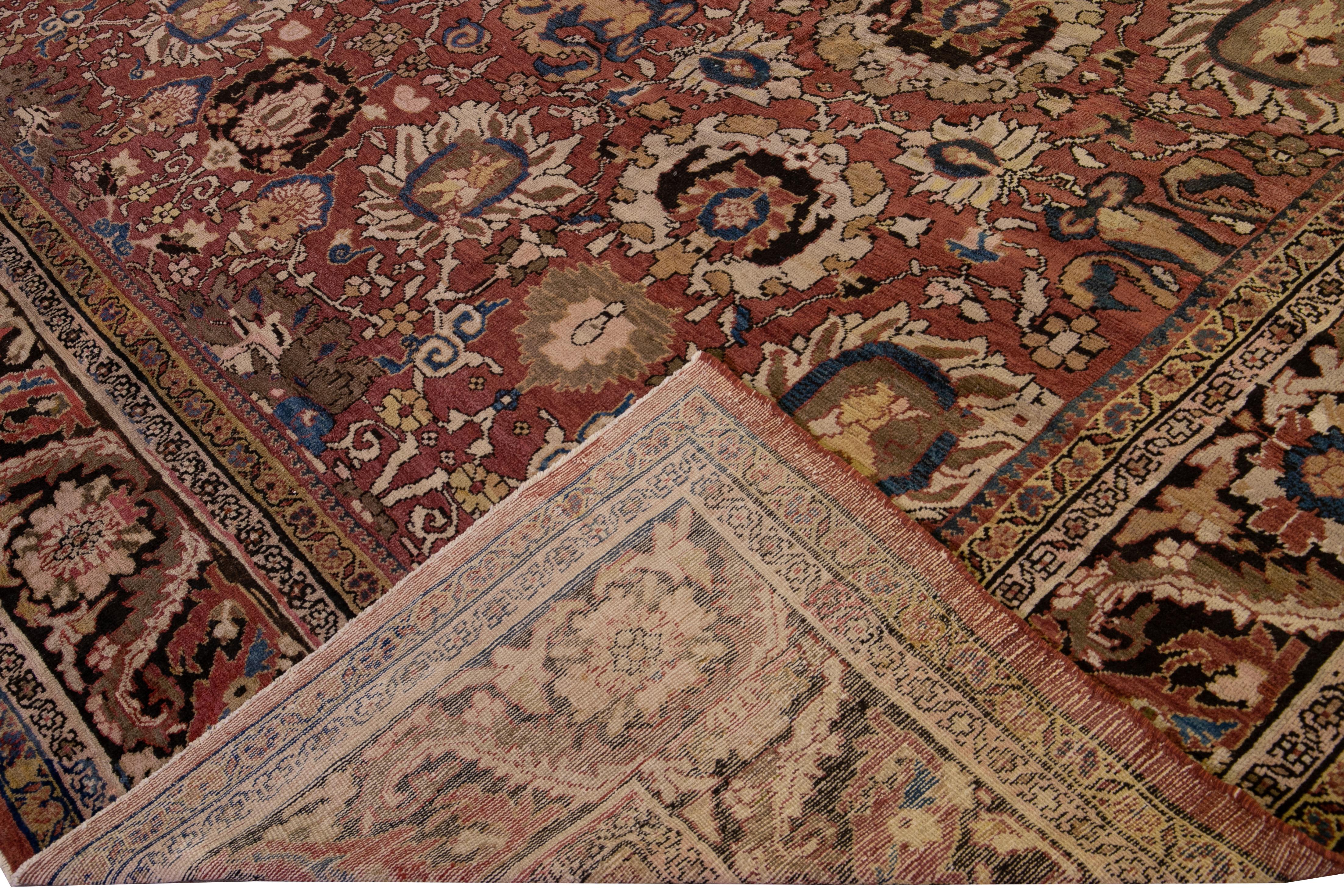Beautiful Sultanabad hand-knotted wool rug with a red field. This antique piece has a multicolor accent in a gorgeous all-over floral pattern design.

This rug measures: 13'10