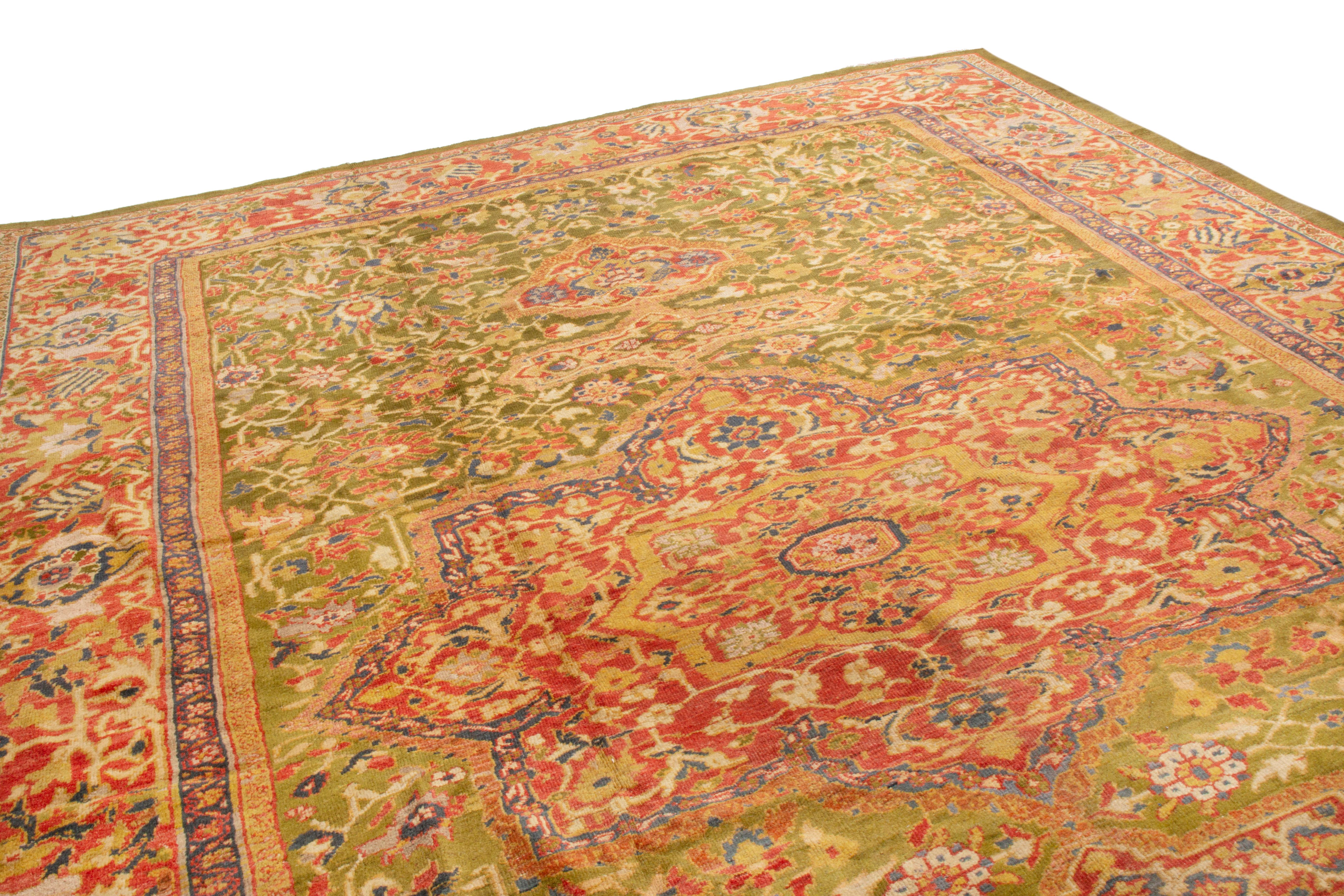 This antique Sultanabad floral rug has very distinct bright colors, inspired from Persian Sultanabad designs and Oushak colors of the area. While most know this piece as a Persian Sultanabad, it may be from a family of Indian carpets made in the