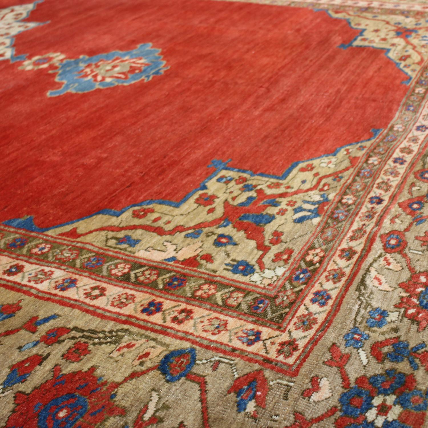 Hand knotted in high-quality wool originating from Persia in 1880, this antique geometric Sultanabad rug hails from one of the most widely regarded cities of antique weaving, enjoying an exceptionally fine medallion field design complementing a