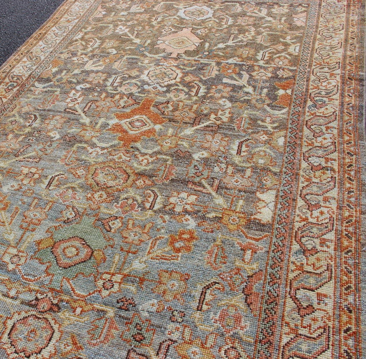 Persian Antique Sultanabad with Muted Background and Hints of Red and Orange For Sale