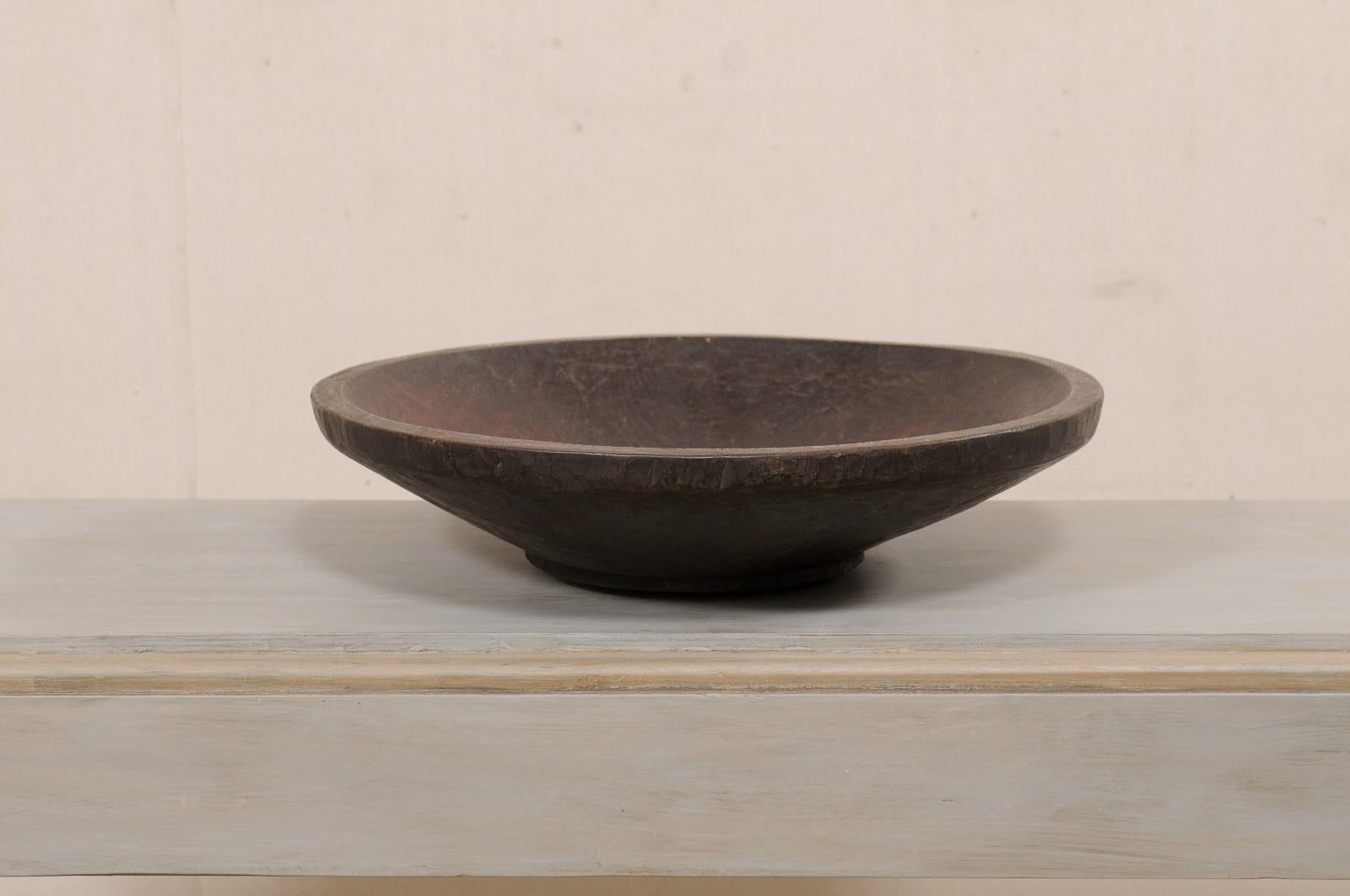 A Sumatran hand-carved wood bowl from the early 20th century. This antique wood bowl comes from the Lampung province of Sumatra, which is locate on the southern most tip of the island. This beautiful wood bowl has been hand carved from a single