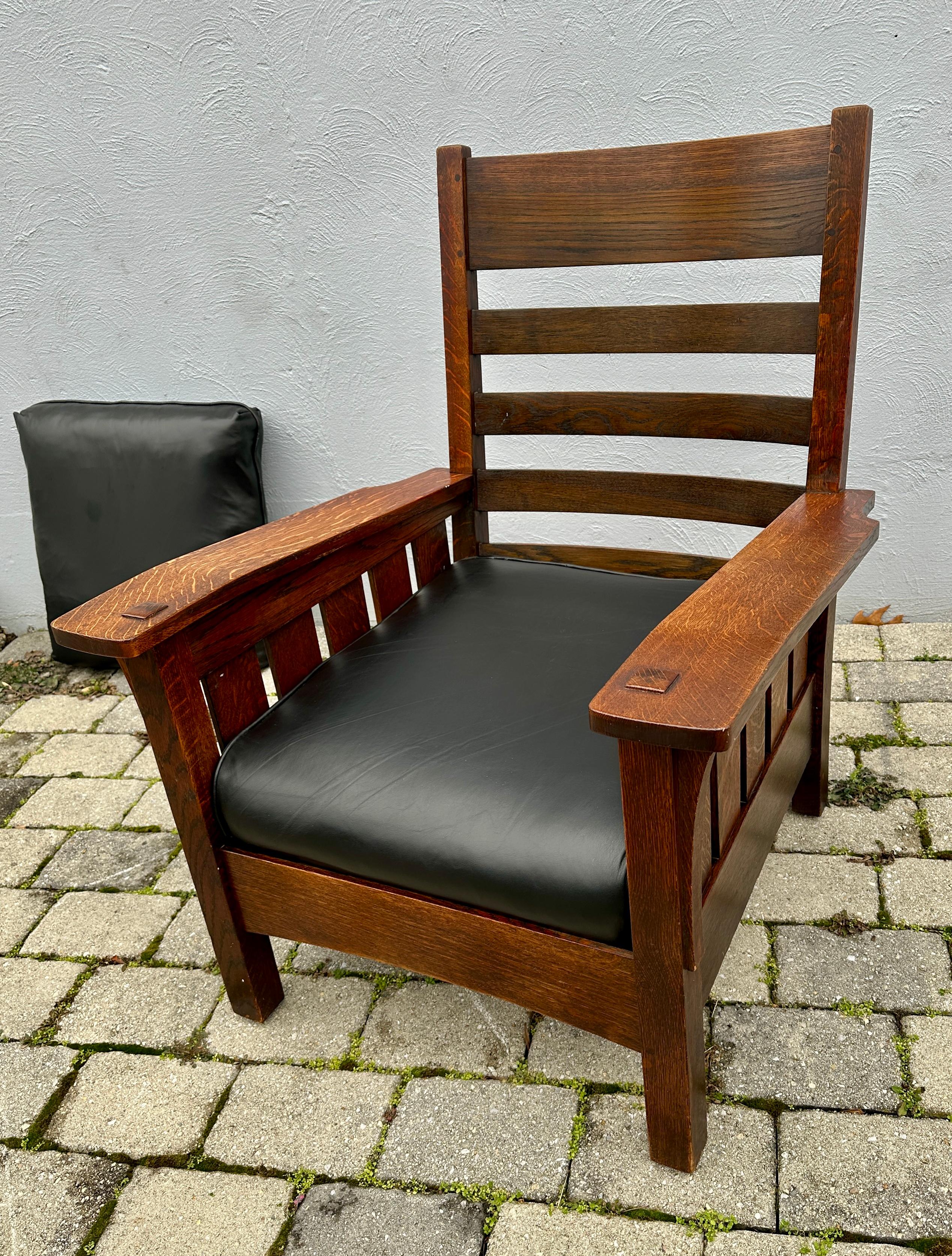 This is a fantastic massive L&JG Stickley chair with slats under each arm.  The chair features bent arms (see photos).  The bent arms give the chair a unique appearance. The chair is in excellent condition with a great original finish and original