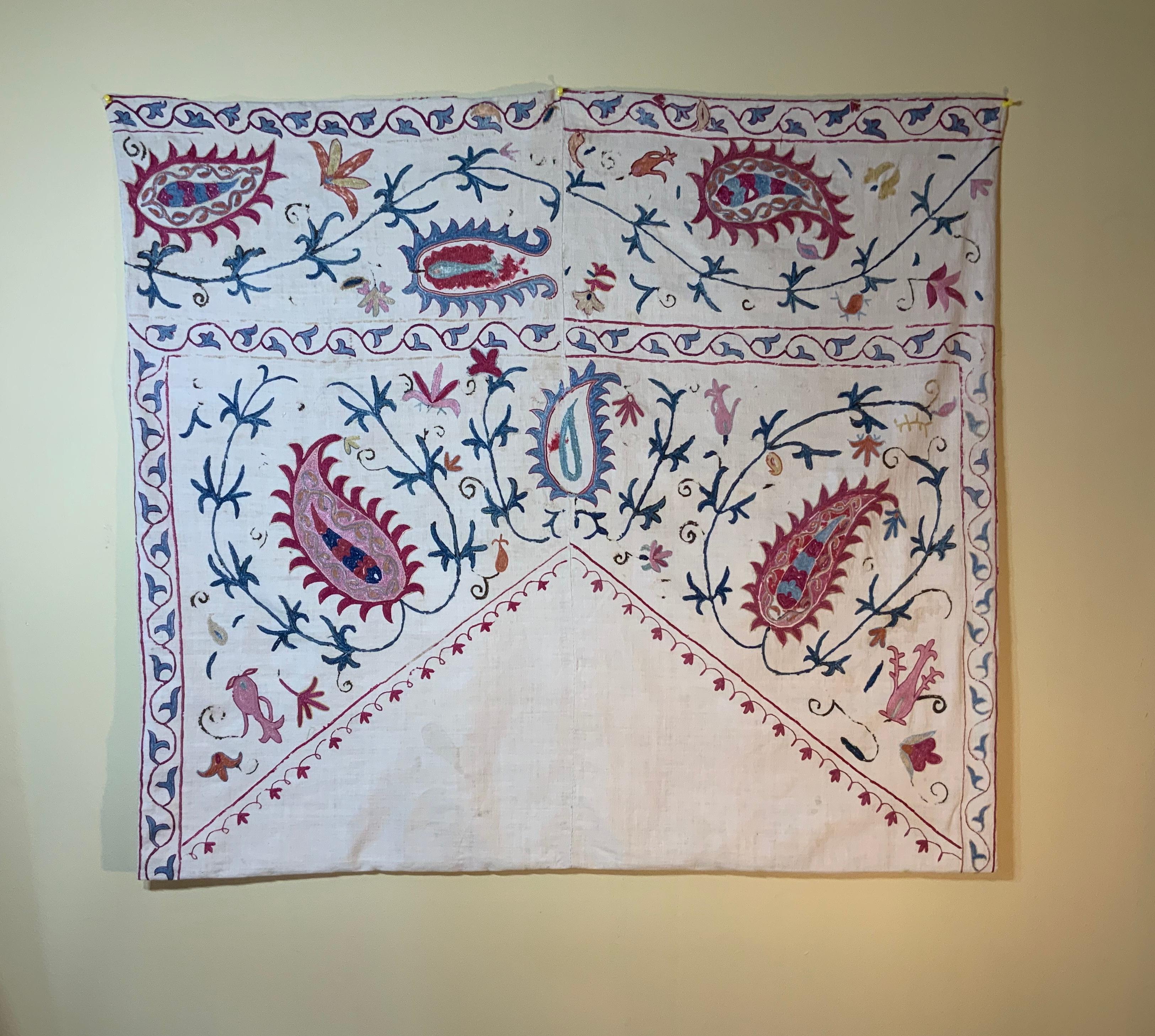 Antique Suzani textile made of hand embroidery, intricate scrolling vines and flowers motifs on a handwoven cotton background. Professionally backed with fine silk textile.
Could use as wall hanging or on top of table or couch.
Exquisite object of