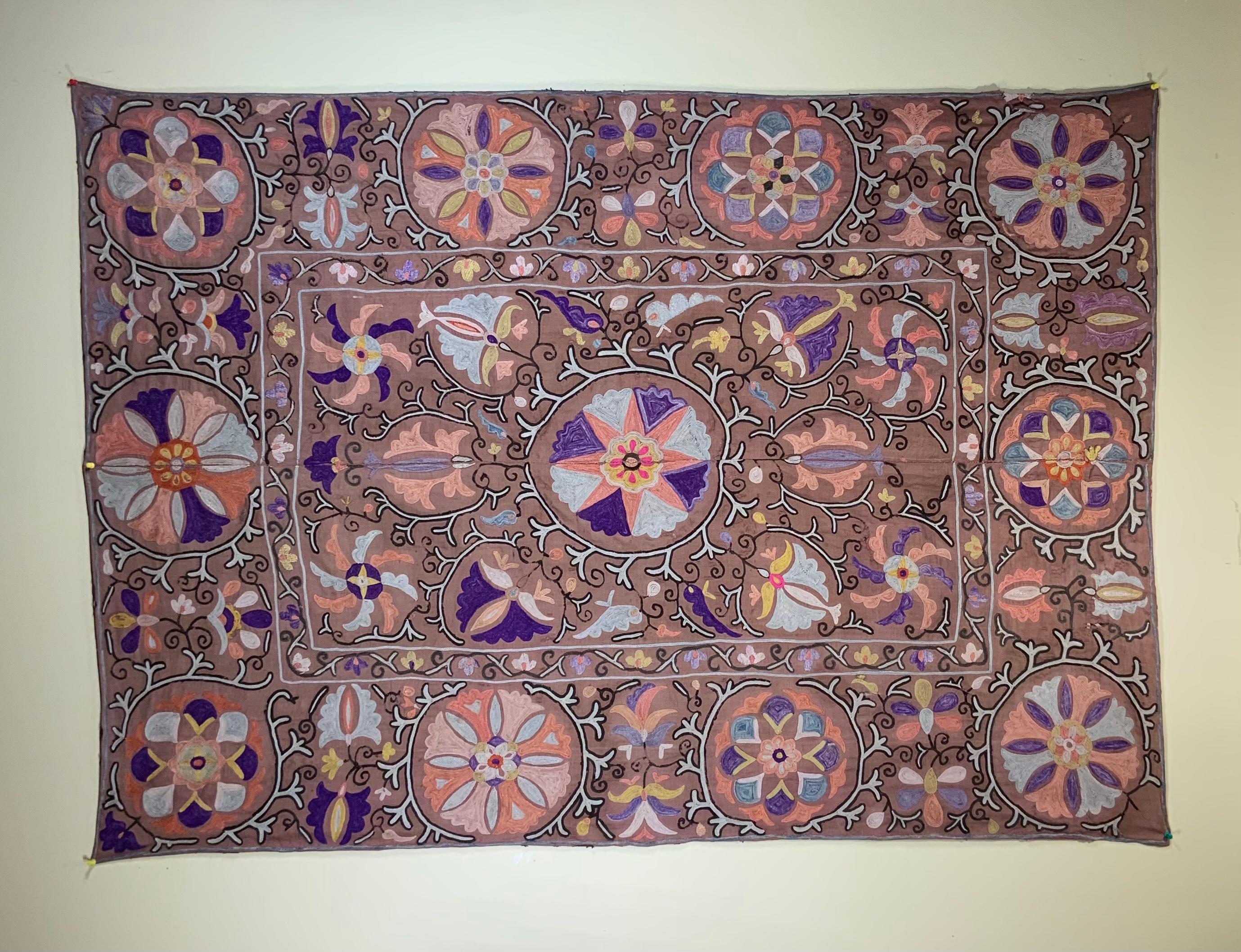 Antique Suzani textile made of hand embroidery intricate scrolling vines and flowers motifs on a handwoven cotton background. Professionally restored and backed with fine linen textile.
Could use as wall hanging or on top of table or