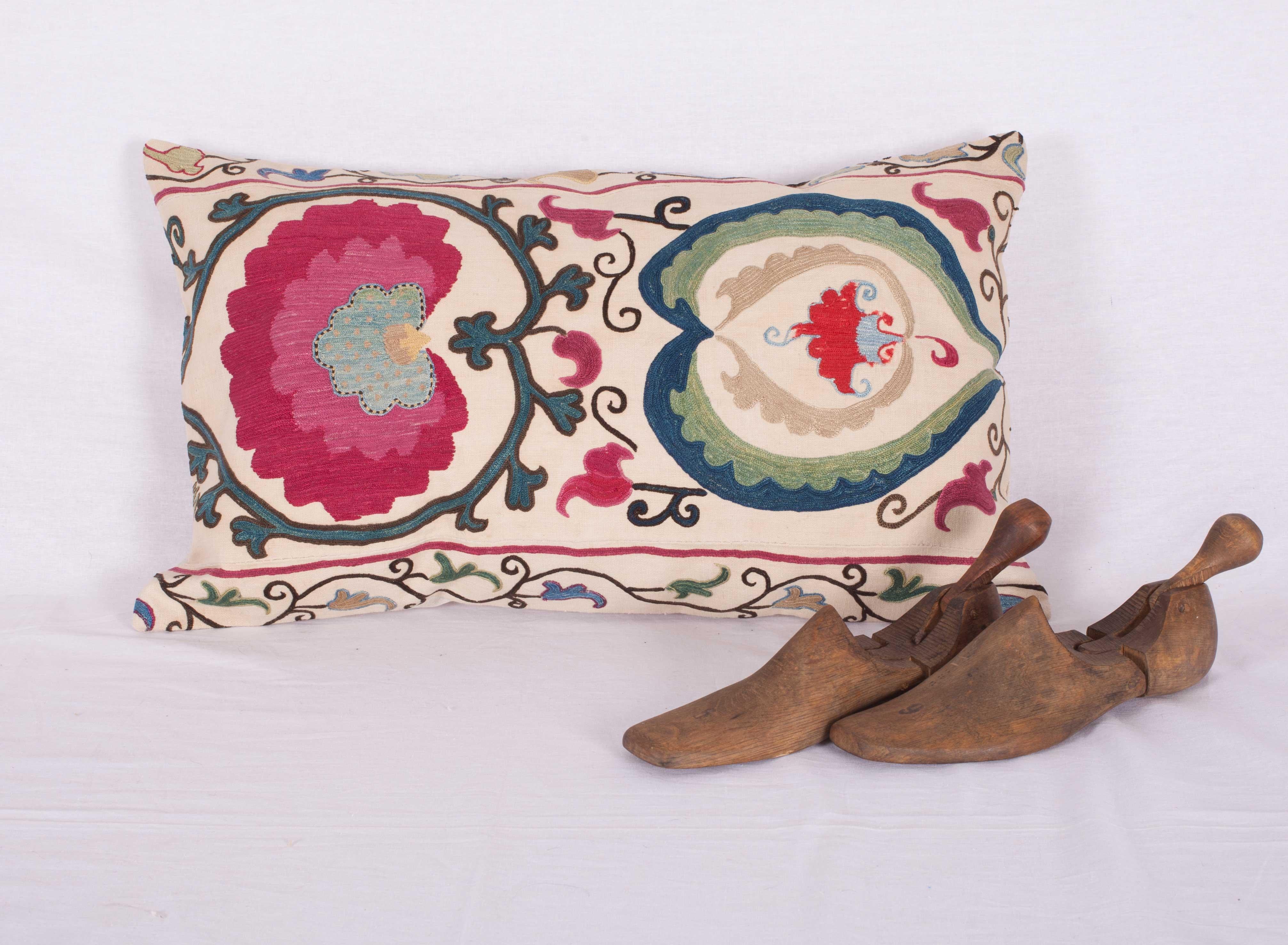 The pillow case is made from an antique Uzbek Suzani from Bukhara. It is silk embroidery on a handwoven cotton field. The backing is pure linen, and they do not come with inserts but bags made to the size in cotton to accommodate insert materials.