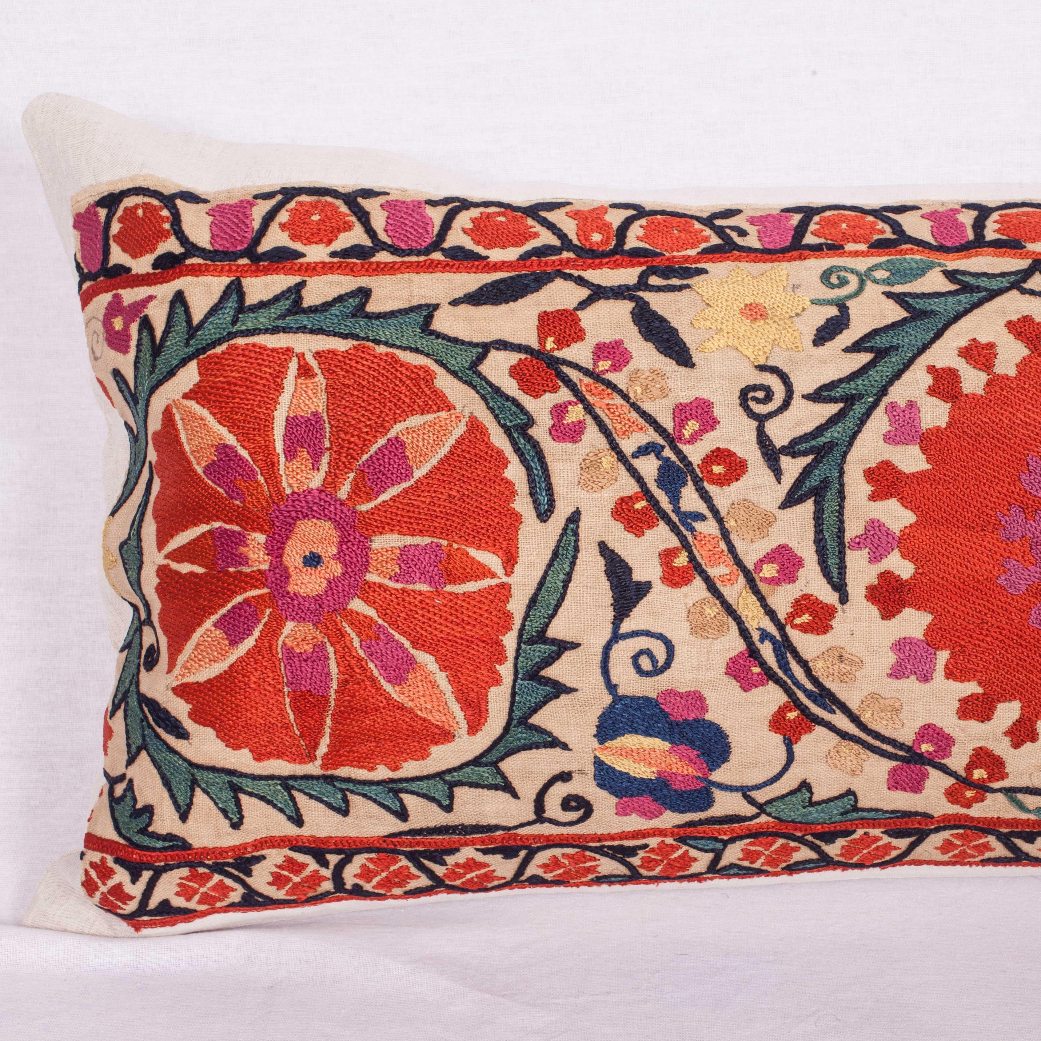 An excellent antique suzani pillow made from the border of a mid-19th century or earlier Nurata suzani. (Suzani fragment has been appliqued on linen professionally and then converted into a pillow case so the embroidery is still intact just incase