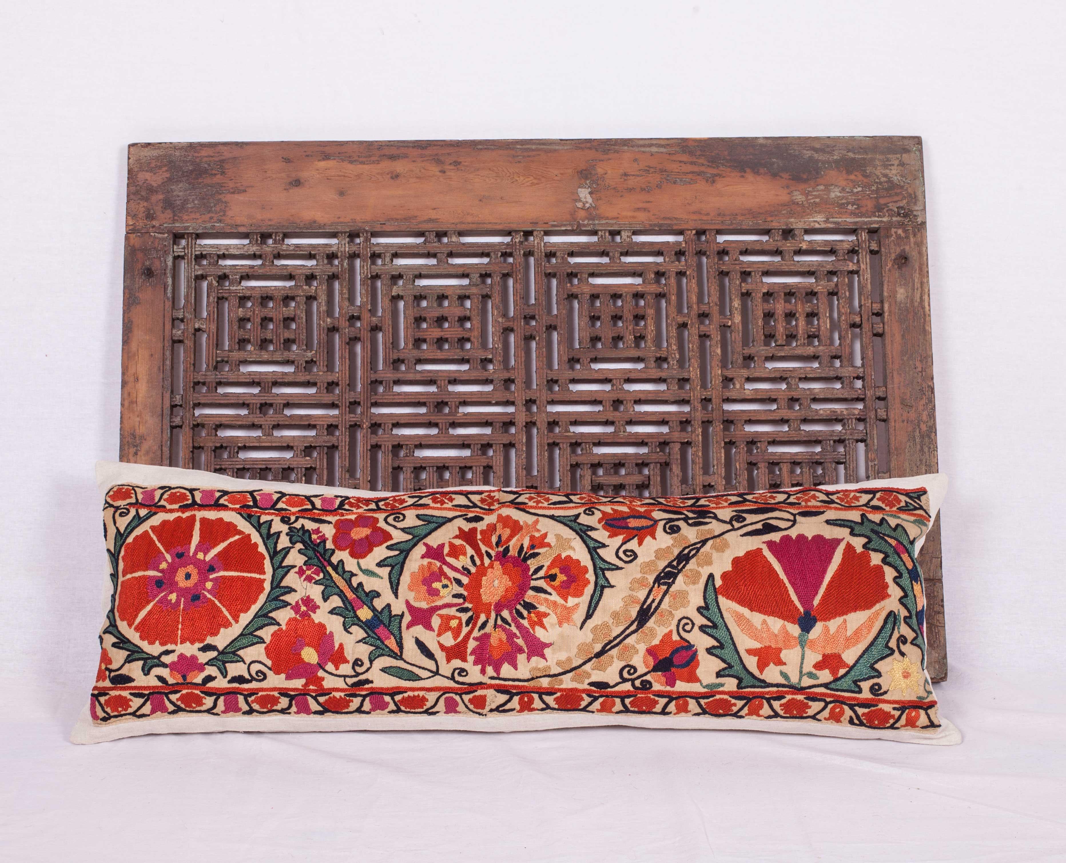 An excellent antique Suzani pillow made from the border of a mid-19th century or earlier Nurata Suzani. (Suzani fragment has been appliquéd on linen professionally and then converted into a pillow case so the embroidery is still intact just incase