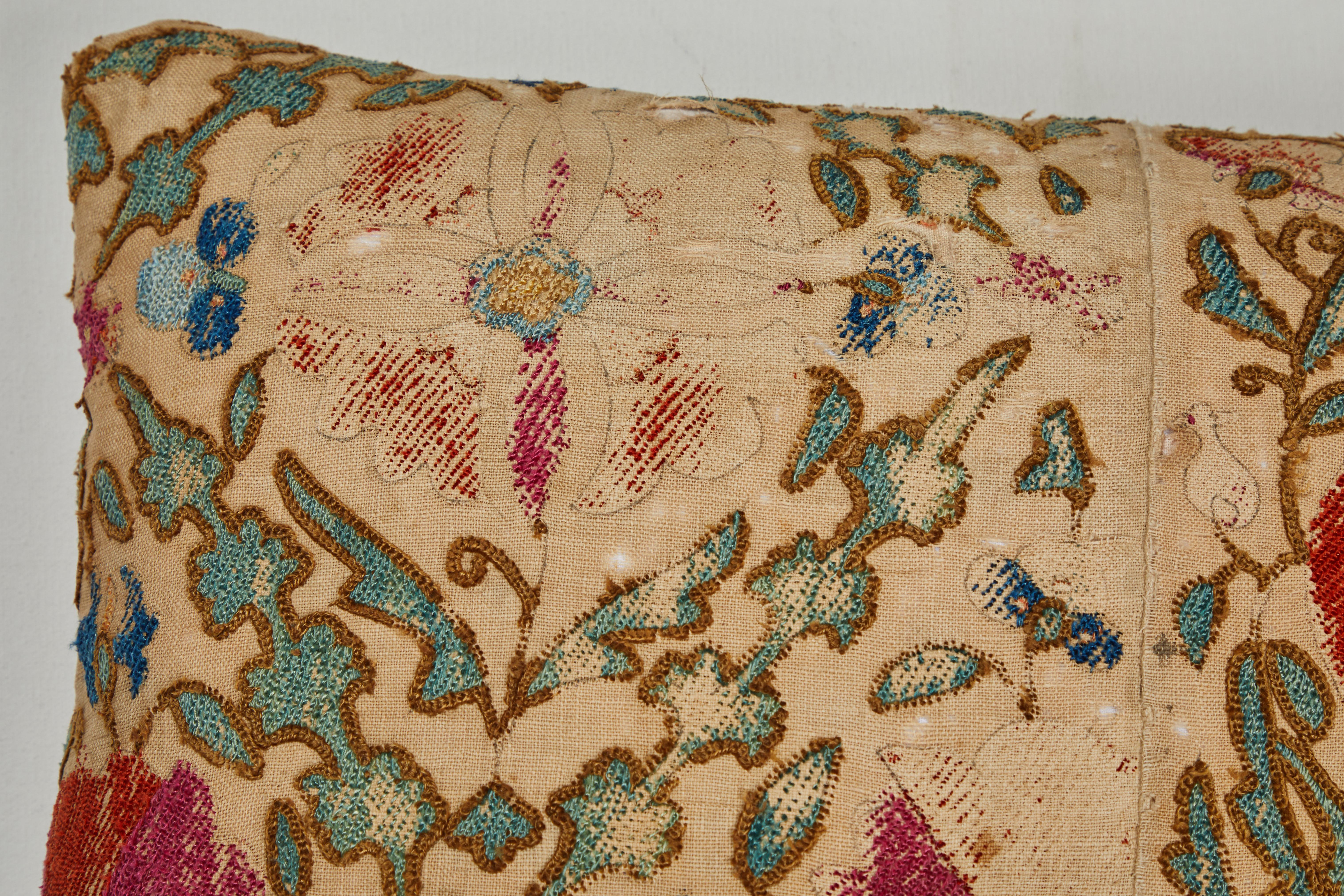 19th century Uzbek Suzani textile fragment. Silk couching and chain stitch on hand woven linen. Lovingly worn. Natural linen back, invisible zipper closure, feather and down fill.