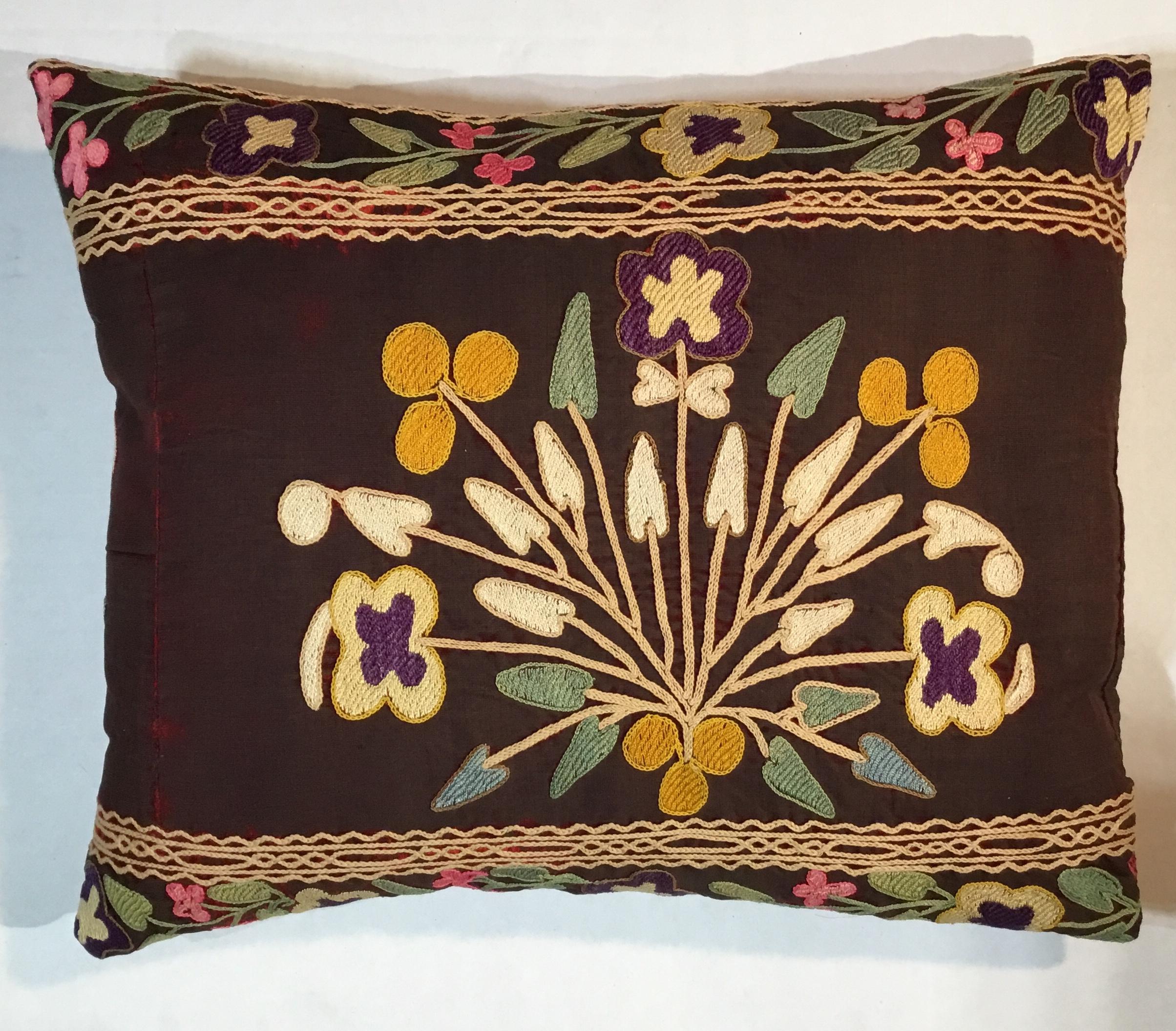 Exceptional pillow made of antique hand embroidery Suzani fragment, beautiful colors ,vines and flowers motifs Embroidery on antique oxidized wine color velvet background , quality cotton backing, fresh new insert.