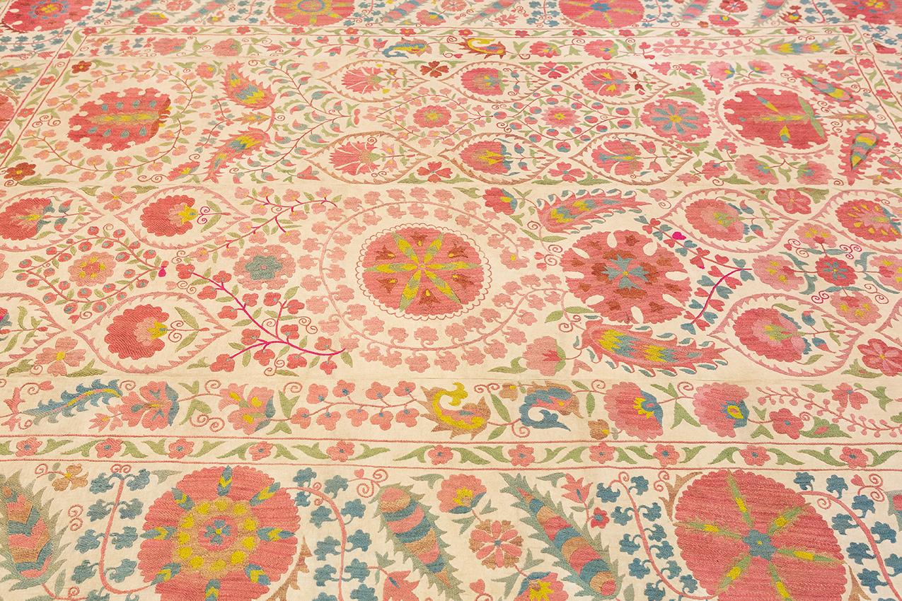 Behold the exquisite beauty of this antique Suzani textile, a true masterpiece of textile artistry with a rich cultural heritage. Traditionally crafted by brides for their husbands, Suzani textiles hold a special significance in Central Asian
