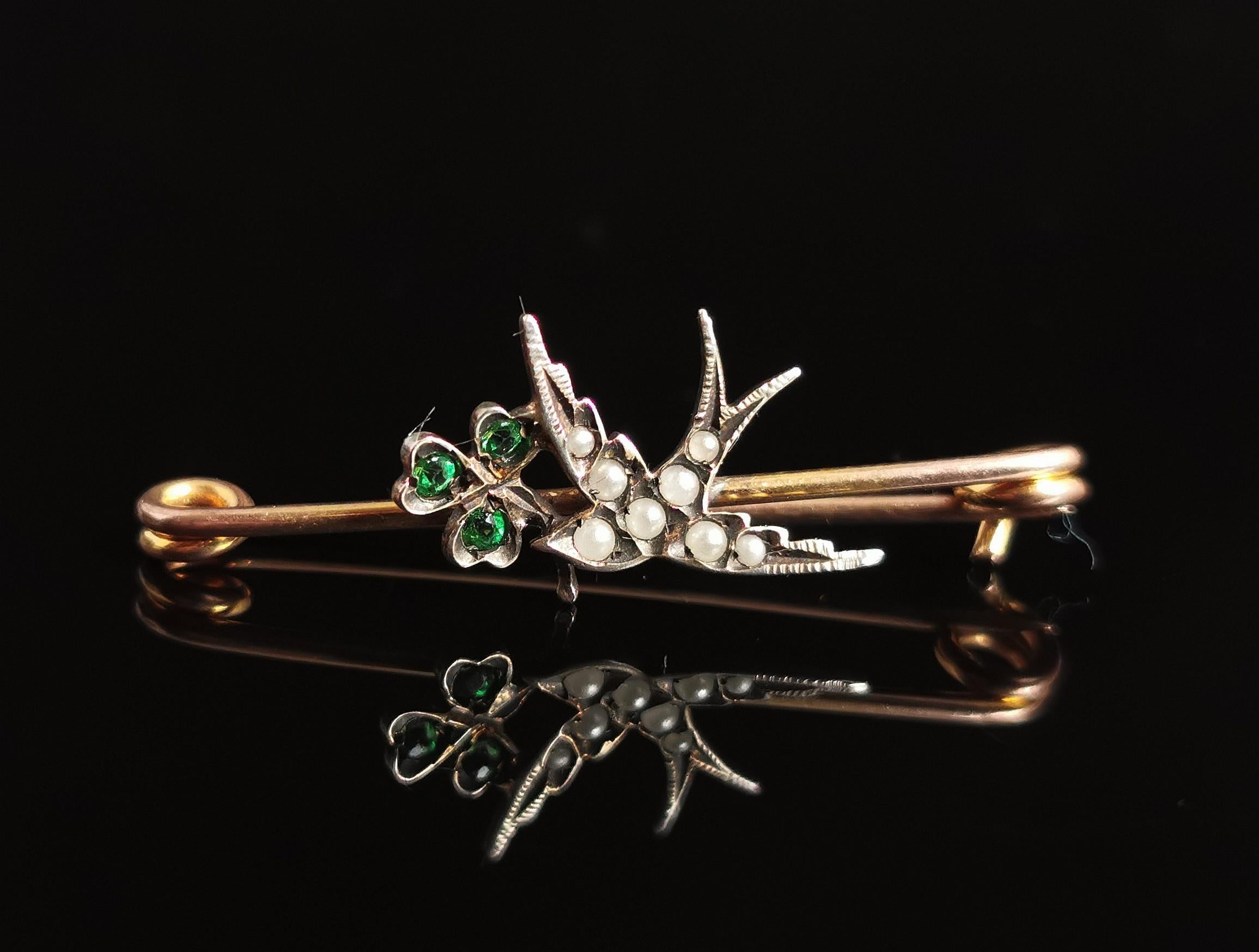 A beautiful antique Edwardian era Swallow and Shamrock or clover brooch.

It is a small dainty piece, very delicate but big on symbolism.

The brooch has an 18kt rolled gold pin mount with a sterling silver Swallow in flight carrying a lucky