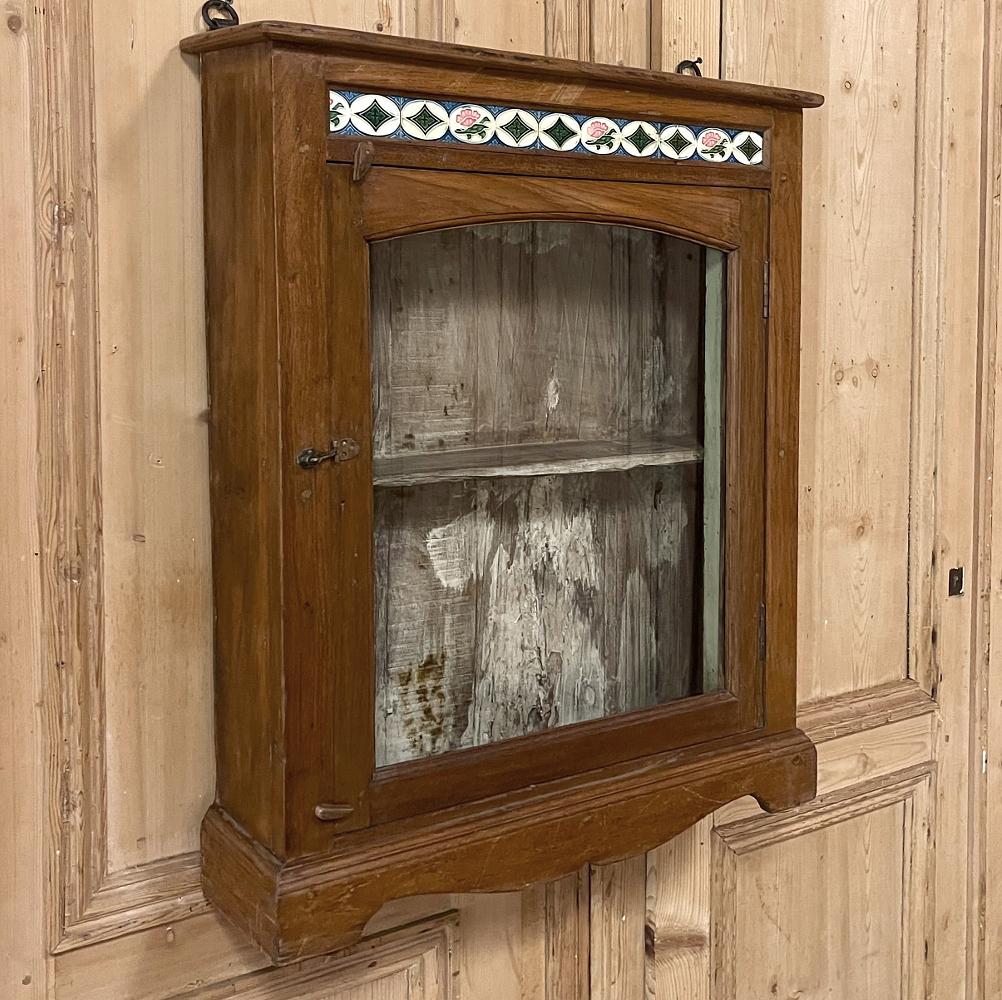 Antique Swedish Arts & Crafts wall cabinet with hand-painted tiles will make a charming addition to your decor, especially the powder room! The casework was fashioned from solid oak, and features a natural finish on the outside with a whitewashed