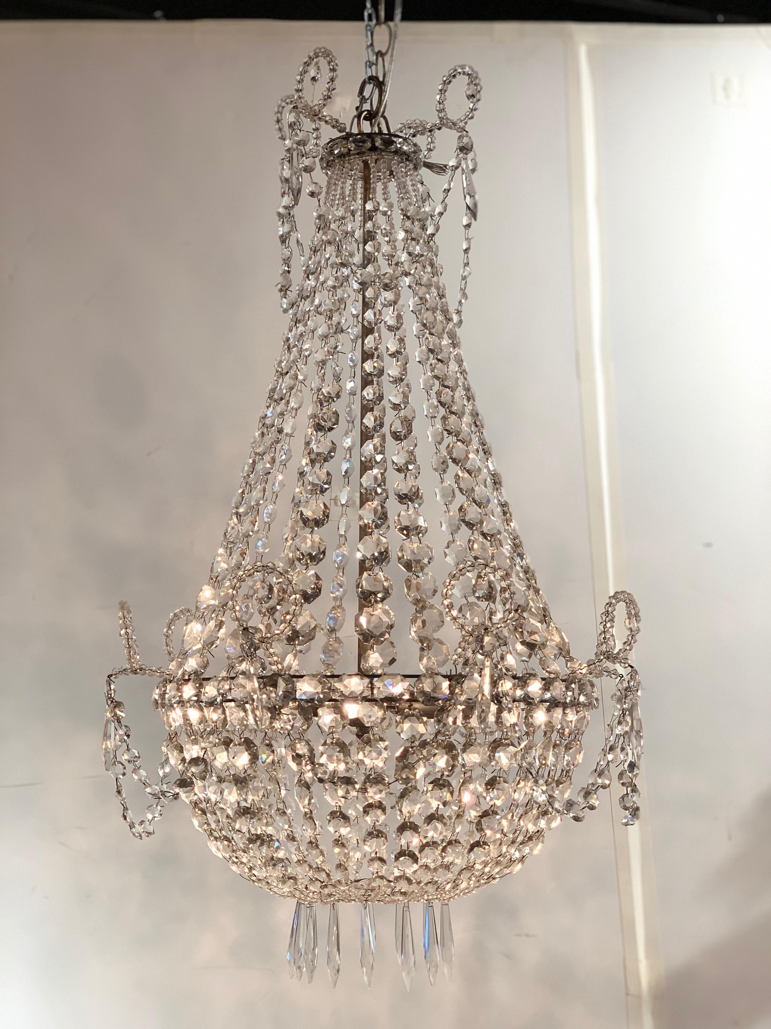 Very elegant basket form chandelier from Sweden with beautiful long strands of cut crystal beads. Re-wired, cleaned and ready to hang. Includes matching chain and canopy.