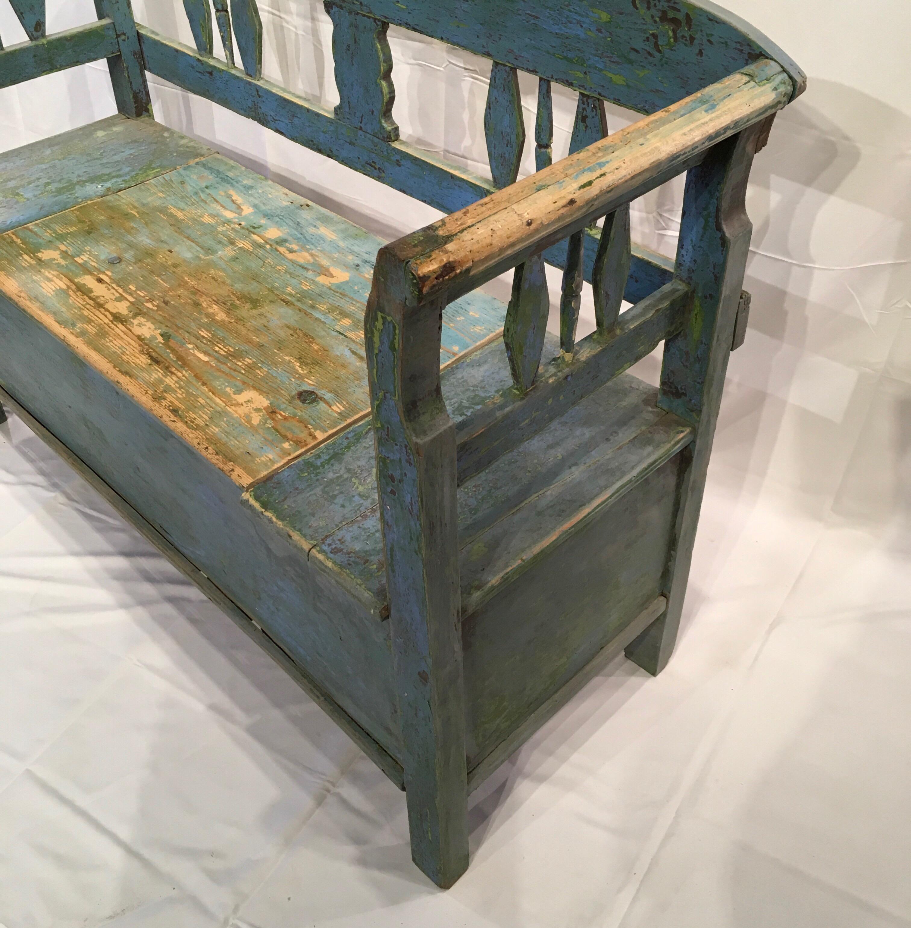 This is a lovely and useful painted bench with storage in the seat which makes this ideal for a hallway or mudroom. This Gustavian piece is finished in a beautiful aged painted patina which enhances the charm of this wonderful piece. The piece is