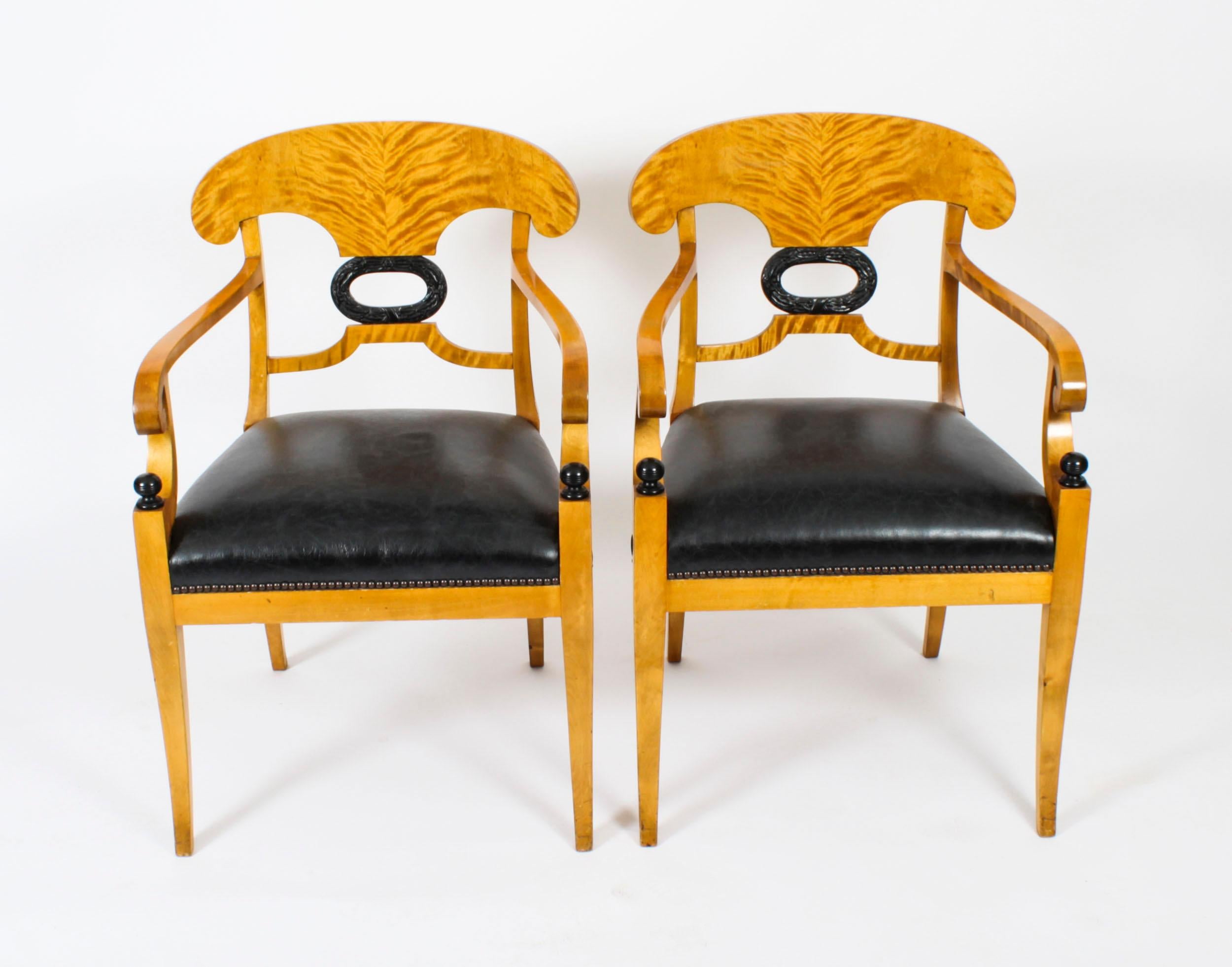 This is an elegant antique suite of four Swedish Biedermeier Karelian Birch wood  chairs, comprising a pair of armchairs and a pair of side chairs, circa 1900 in date.

Crafted with exquisite attention to detail, these chairs feature a sturdy wooden