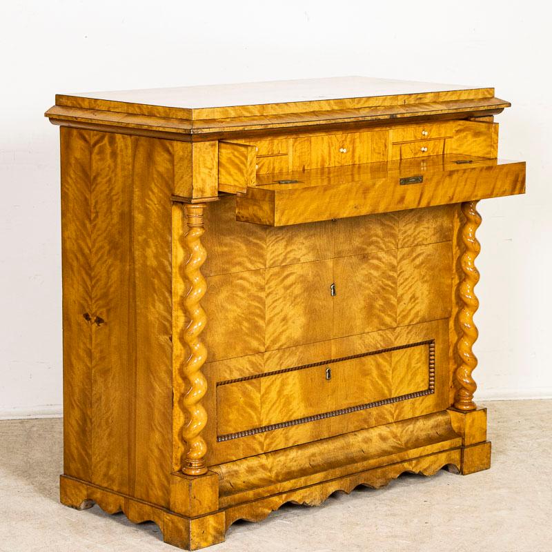 The evocative burled birch is captivating in this remarkable Biedermeier chest of drawers. Please enlarge photos to appreciate the finish, barley twist columns, and beaded detail of the bottom drawer. Unique to this chest is the upper section which