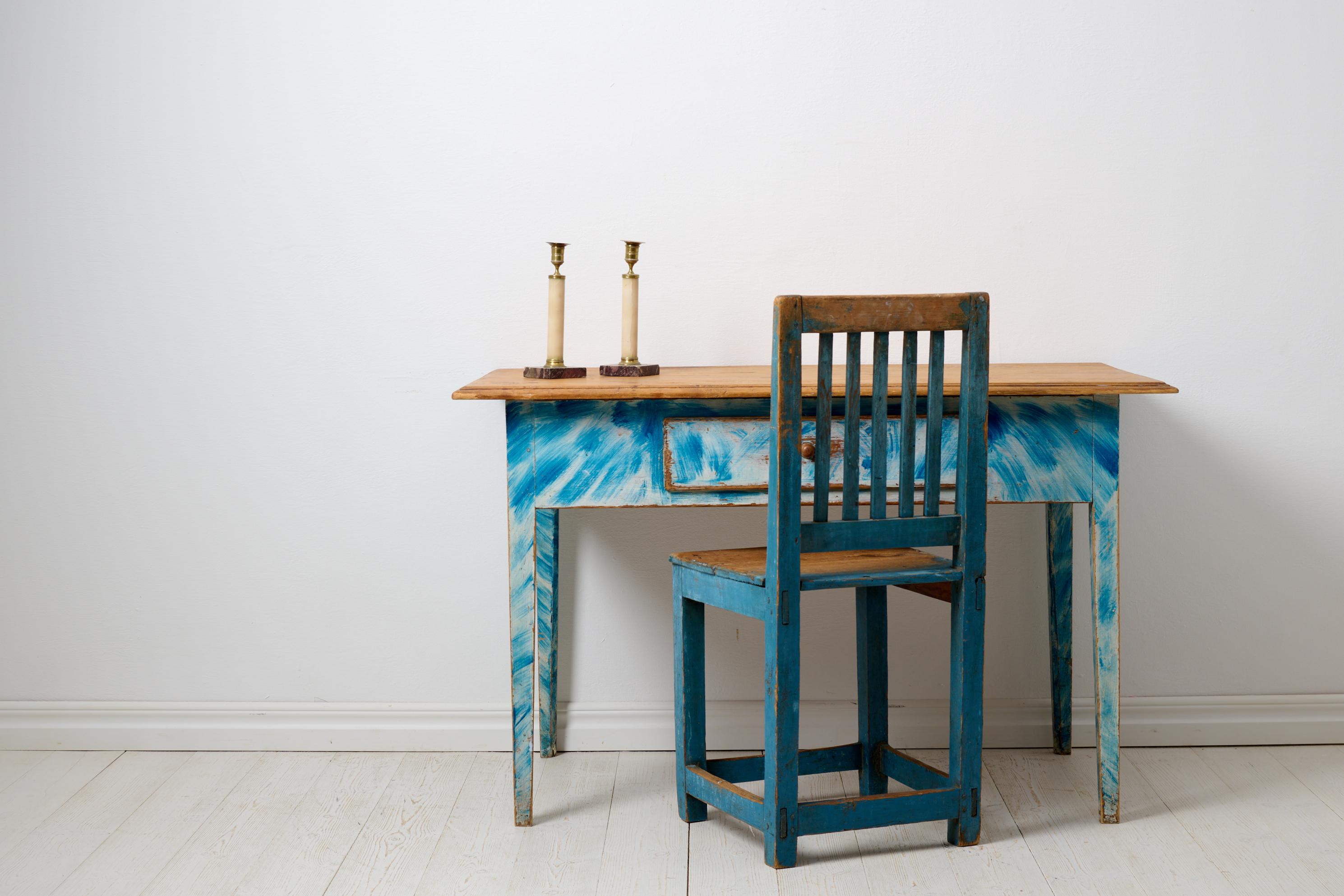 Blue antique country table in Gustavian Style. The table has a very unusual and charming original paint in blue and white, which are rare colours. Healthy and stable frame as well as a functioning drawer with an original drawer pull. The table is