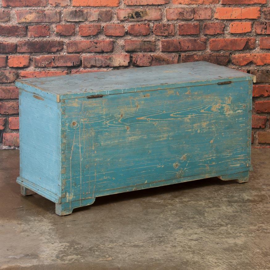 This late 19th century Swedish pine trunk is simple yet charming with it's clean lines and soft contrasting hues of old blue paint. Take note of the exposed dovetail joinery and bracket feet. This trunk is the perfect, casual accent piece that will