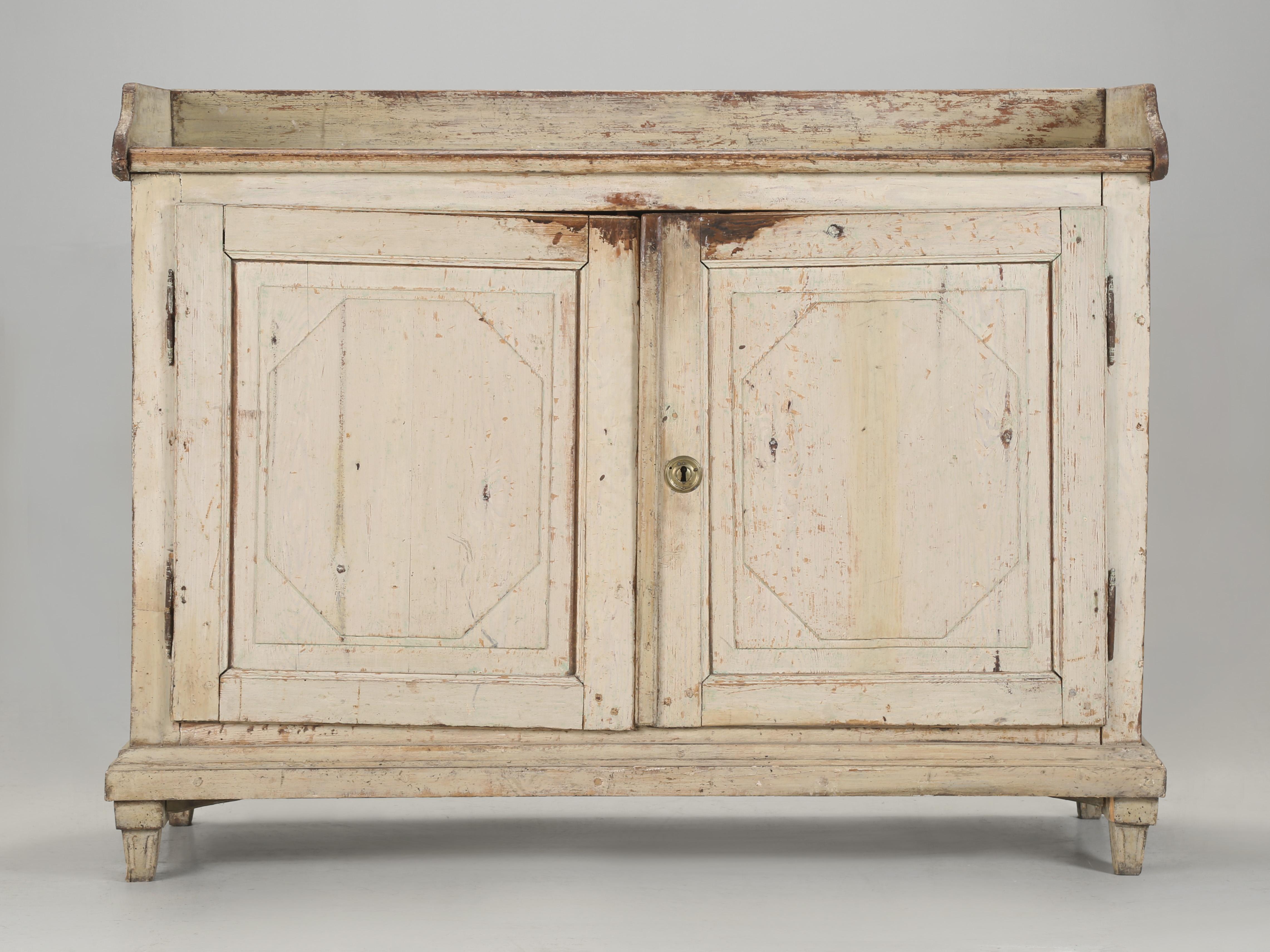 Antique Swedish Buffet from the late 1800's in Original White Paint with (3) Drawers located inside the cabinet. If ever there was a perfect distressed white painted finish to copy, this Antique Swedish Buffet would be a perfect example of how a