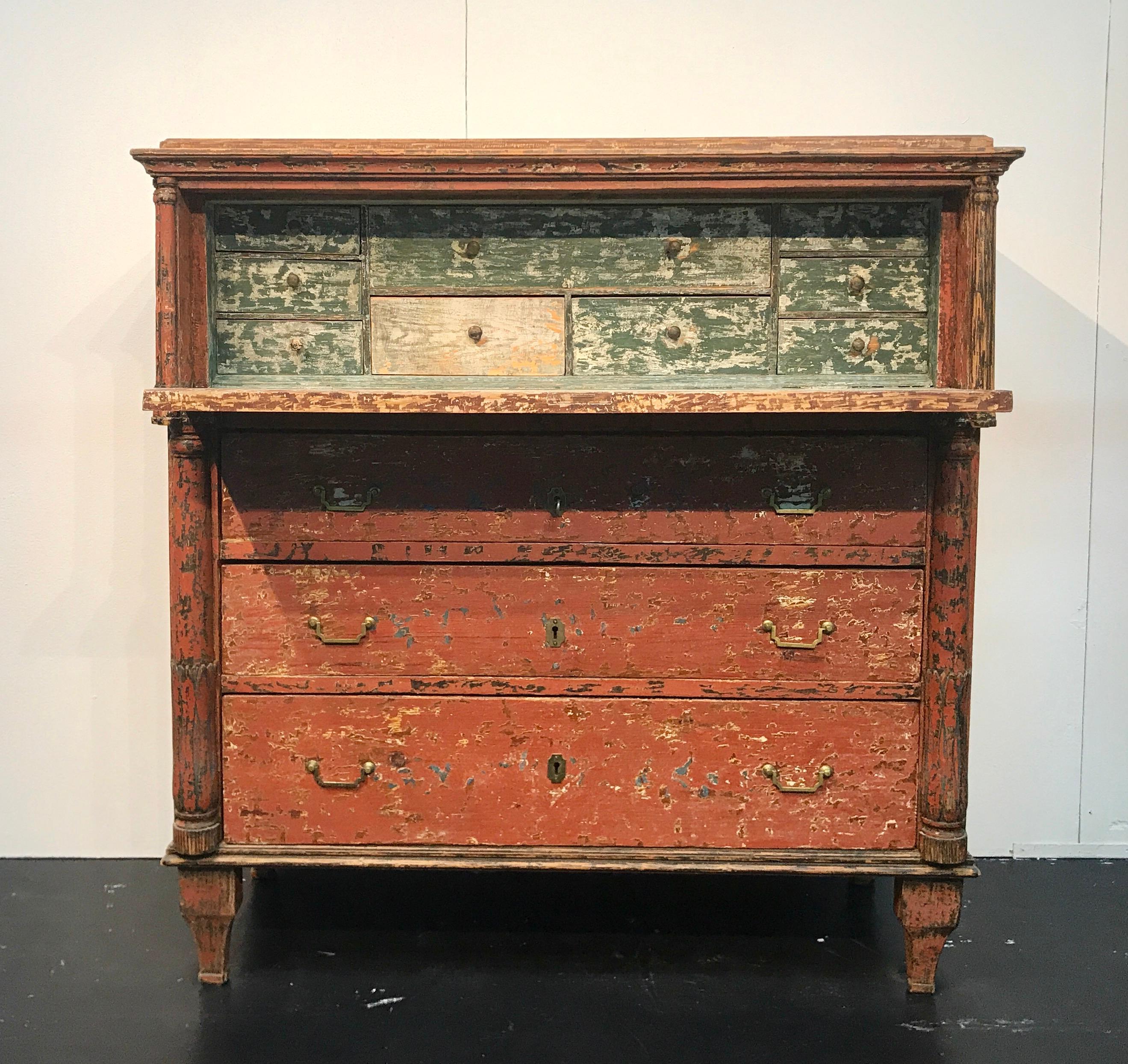 Unique Swedish chest of drawers with fall-front top drawer with original painting produced circa 1850. Three are three big drawers at the bottom and ten small drawers inside. On the corners there are beautiful decorated columns. The exterior is a