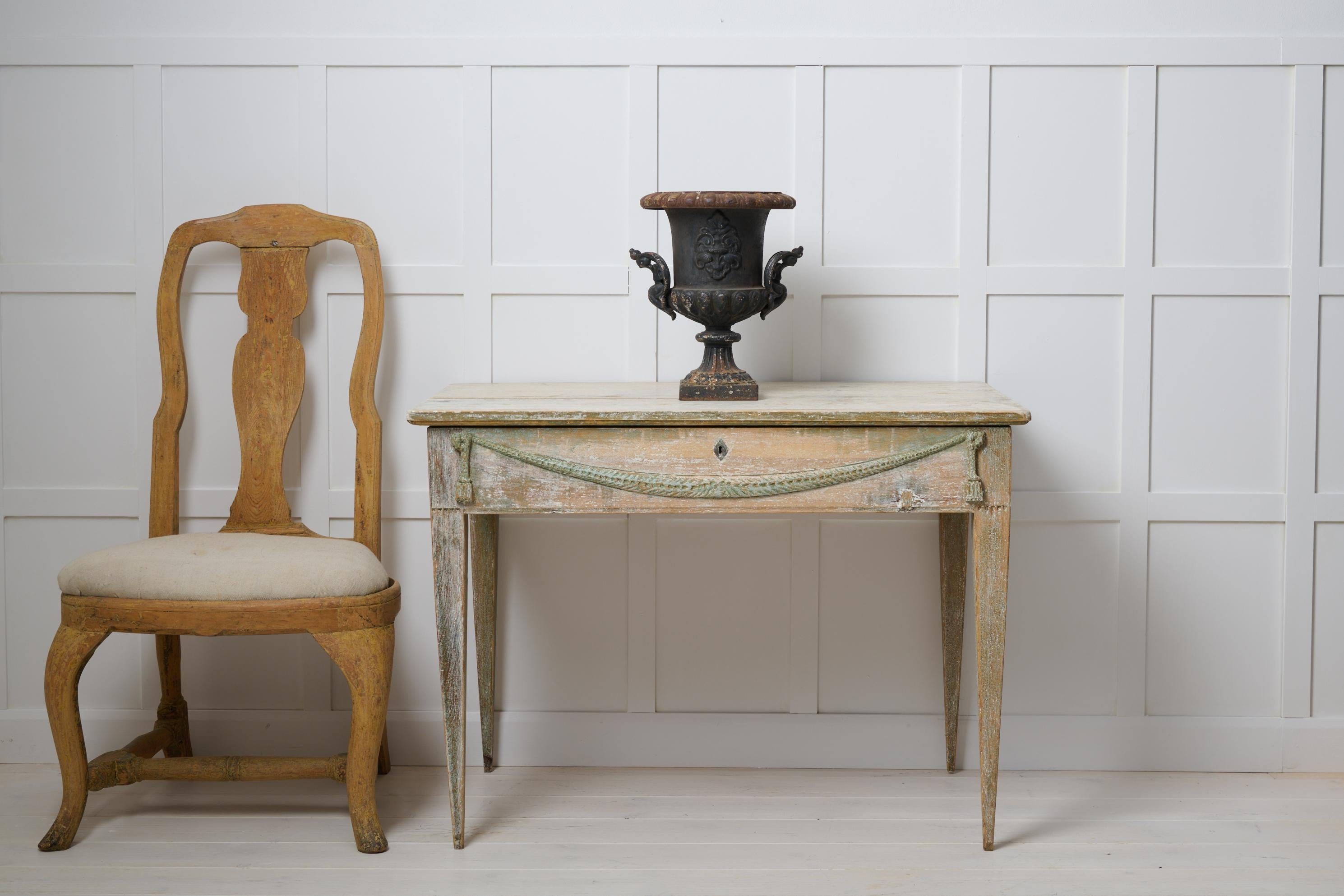 Antique Swedish console table or wall table in gustavian style. The table is a genuine antique made by hand around 1790 to 1800 in northern Sweden. The table is solid pine with straight tapered legs. There is also storage underneath the table top.