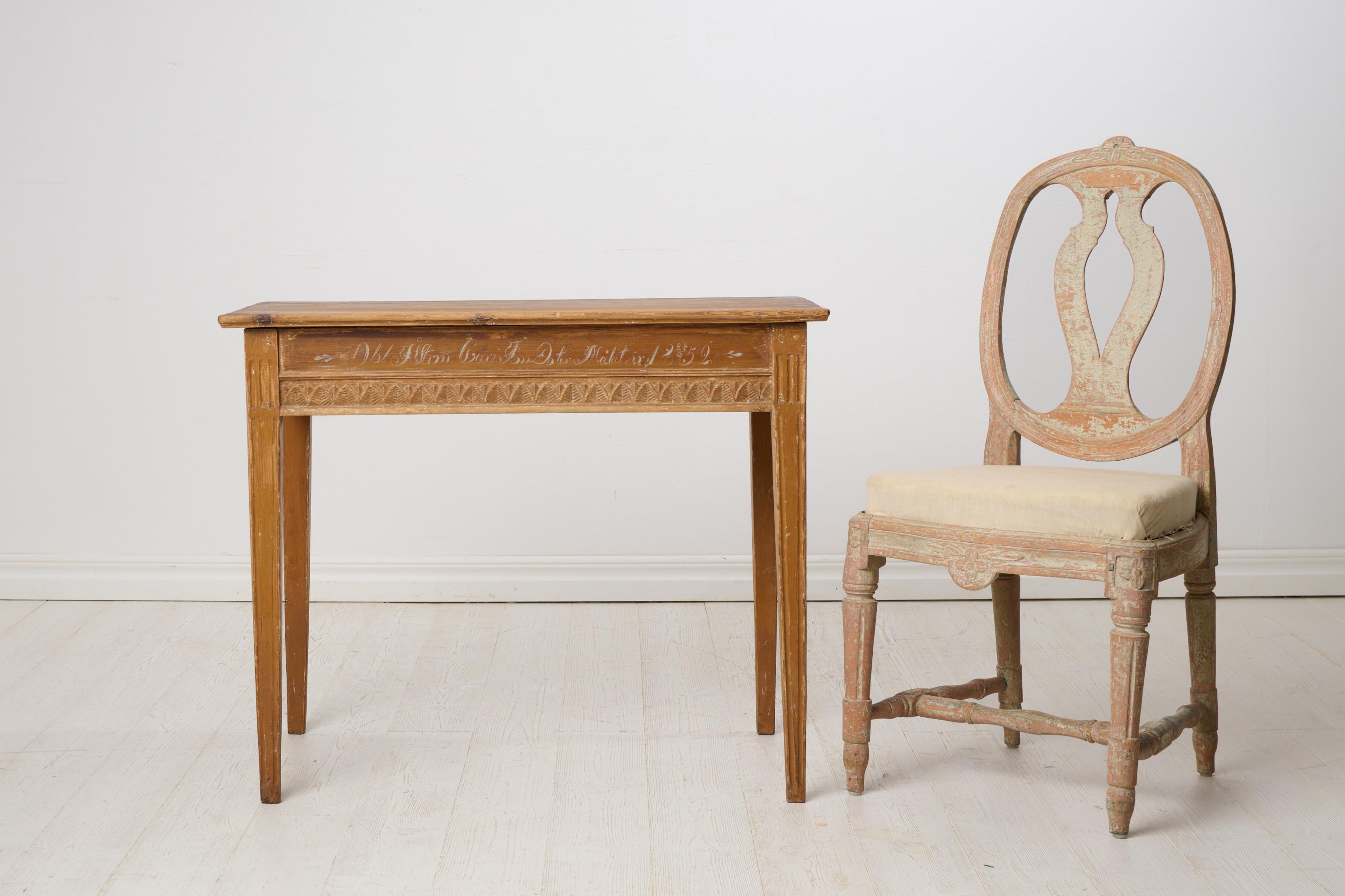 Antique console table in gustavian style dated September 24th 1852. Straight tapered legs, apron with period-typical gustavian carved leaves. Original thin paint which is slightly worn by the passing of time. Initials and dating on the front along