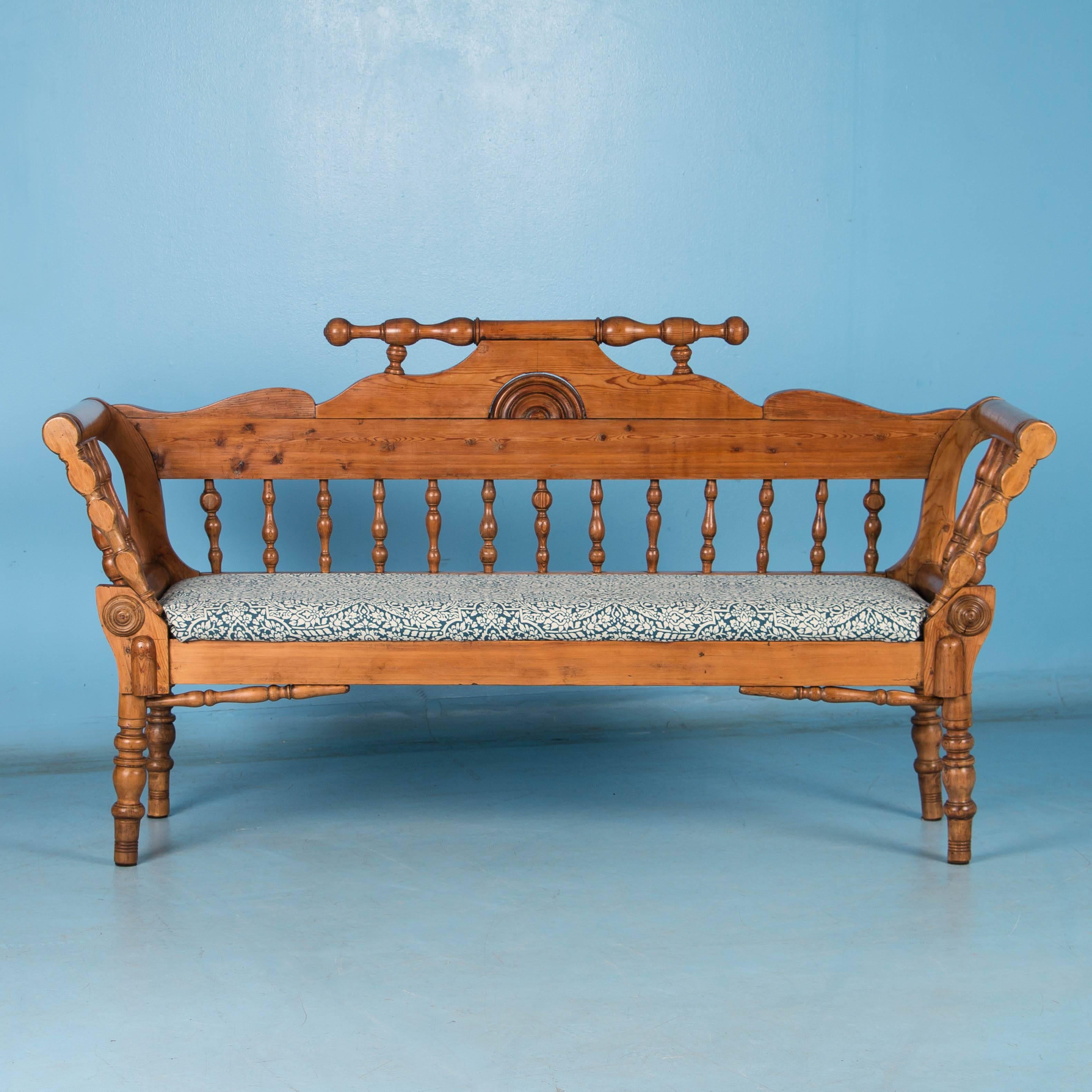 The pine glows on this unusual Swedish cottage style bench with all of it's turned spindles and legs. The wax finish enhances the color and patina of the wood and works beautifully with the country look. The upholstered seat is removable which makes