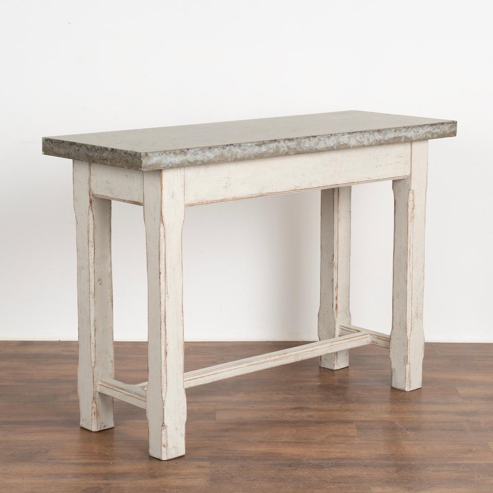 Swedish console table with stunning stone top. This versatile table may also serve as a small server, buffet or even kitchen island.
Please refer to the close up photos to appreciate the lovely details and natural beauty of the stone
