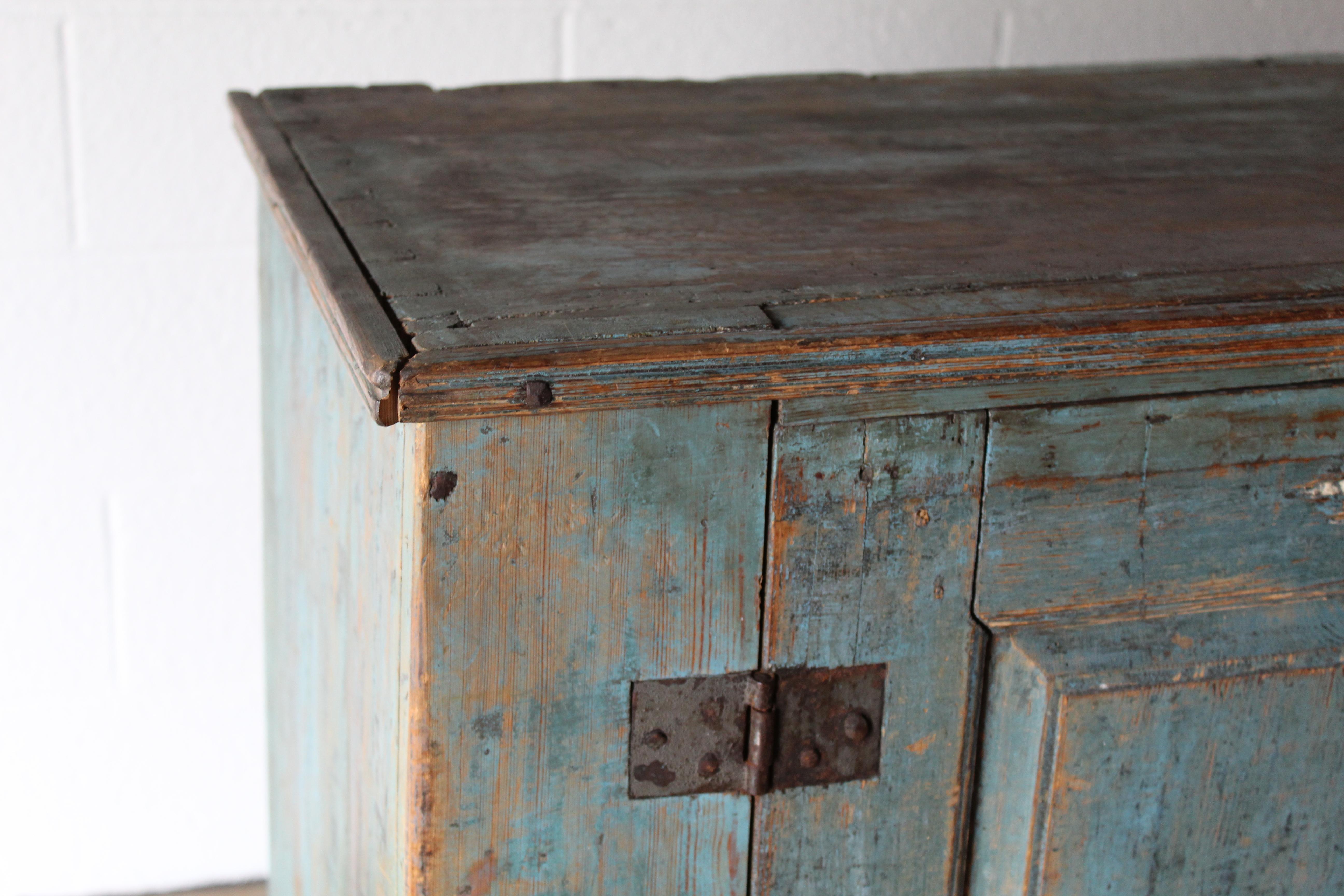 18th century Swedish cupboard with blue paint. It has a two-door front, with 2 shelves inside. Original working lock and key.
