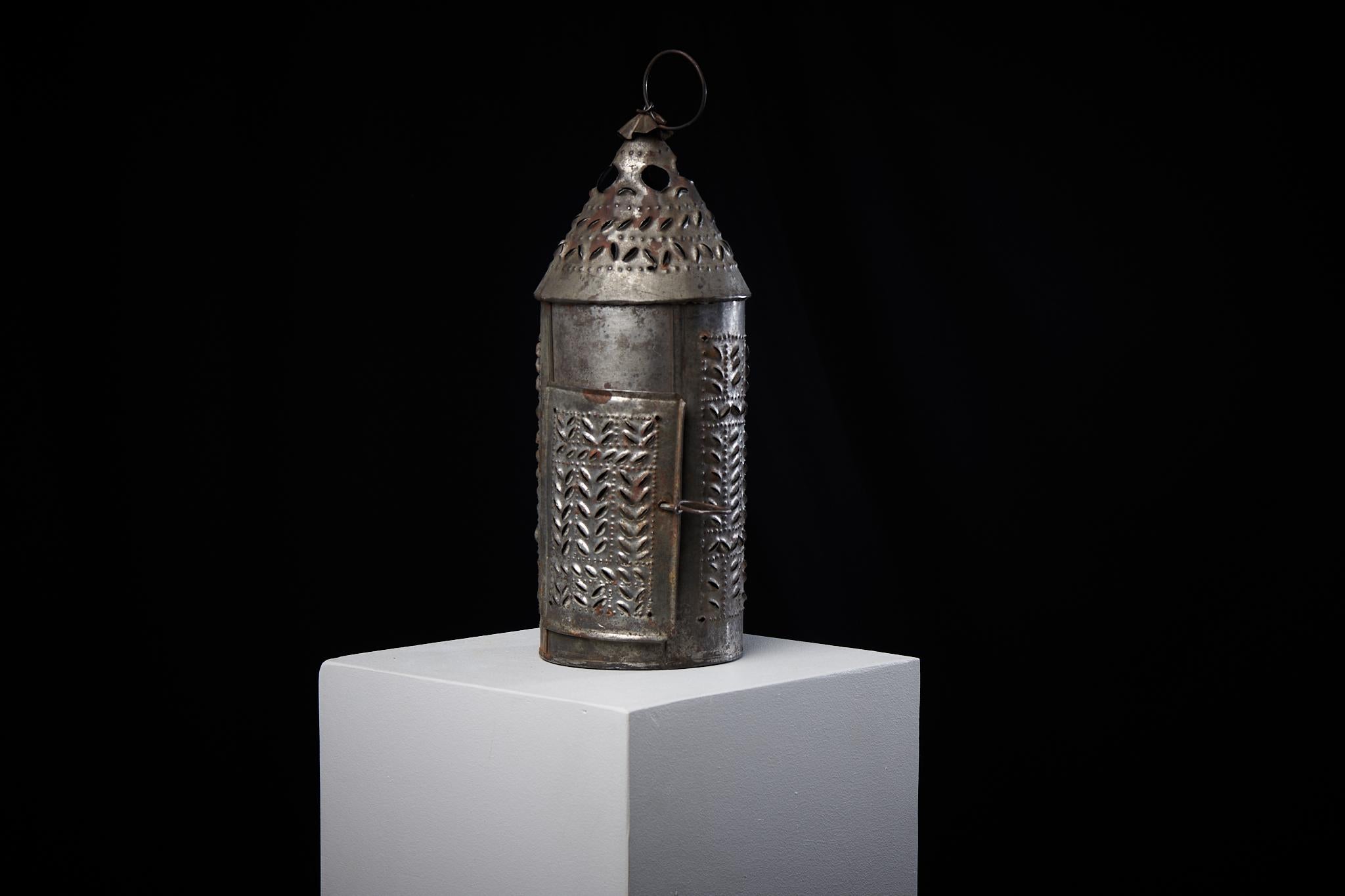 Unusual iron lantern from Sweden made during the mid 1800s. The lantern is folk art and has a cut-out pattern that’s been made by hand. This type of lantern is known as ”spiklykta”. They were used by women when they attended church during the cold