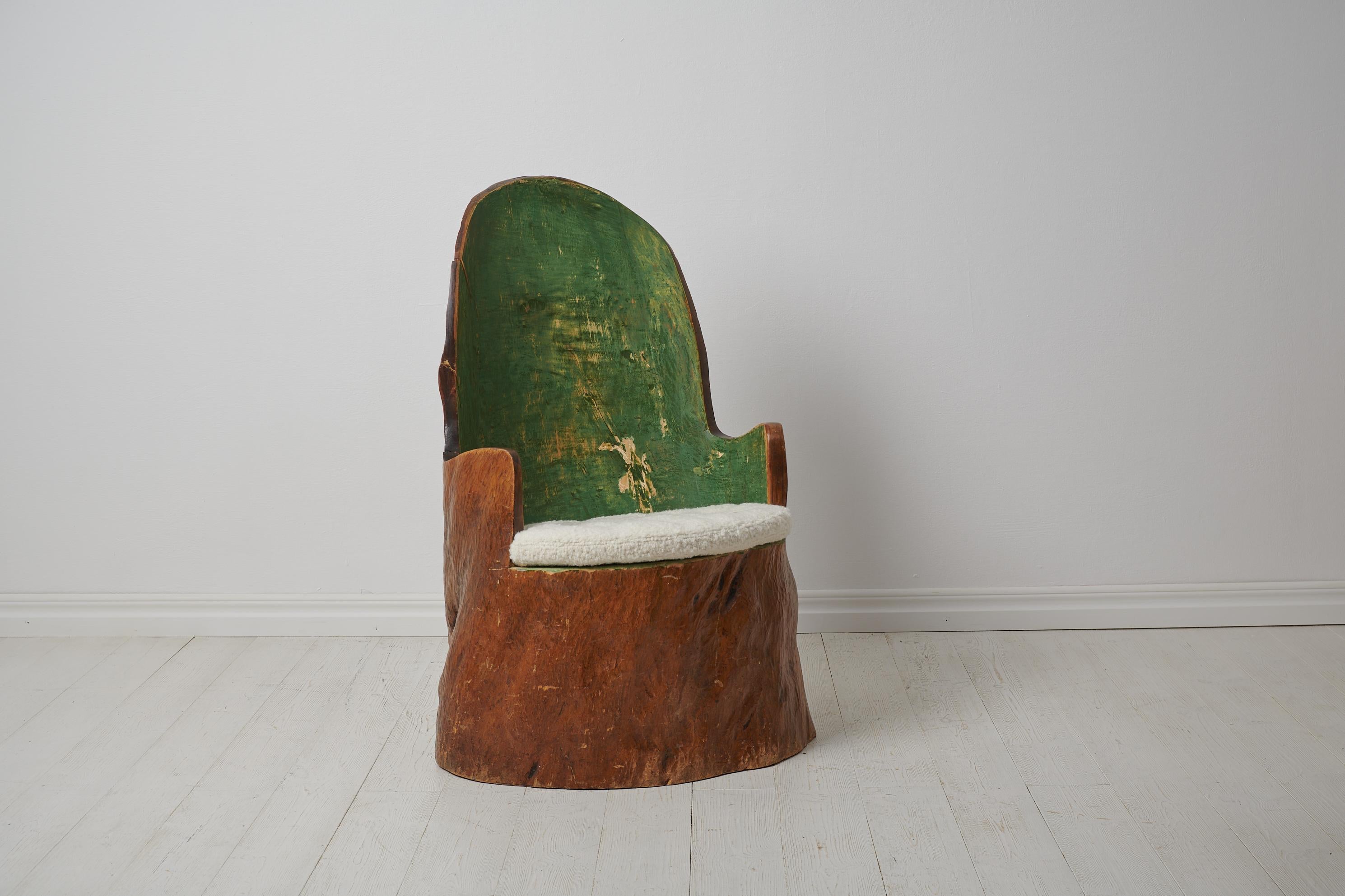 Antique Swedish ”Kubbstol” or ”Stockstol” as they are also known. The chair is a primitive furniture made by hand from one large, solid log of wood. The log has then been hollowed and shaped into the current form. Made from pine around the turn of