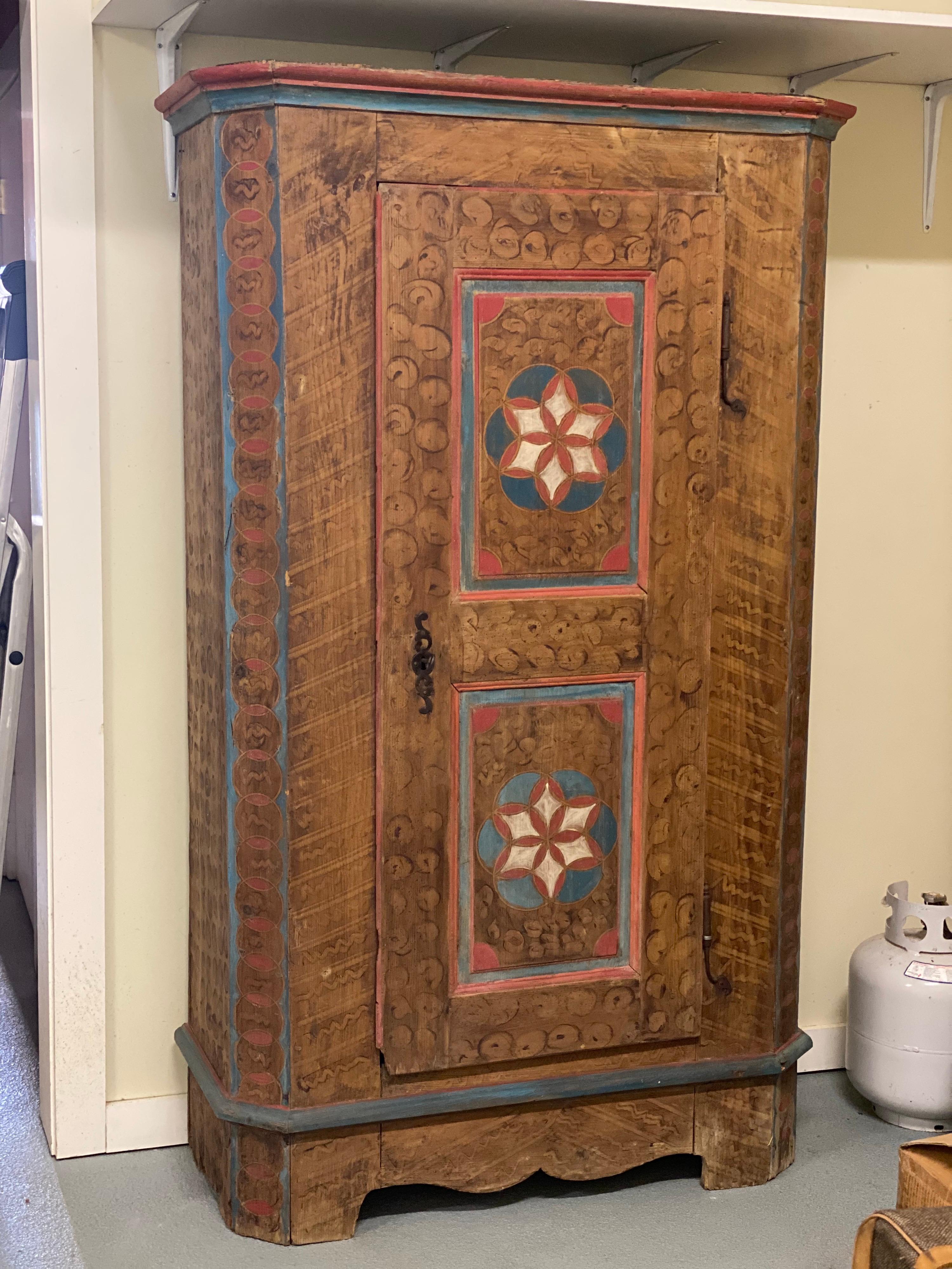 Antique Swedish folk art painted cabinet
Flower motif on central panel of door. Sponge painted with dark circles and blue and red perimeter paint. Unique piece.

Measures: 18.5” deep x 42” wide x 76” high

Good condition.
Provenance: Private