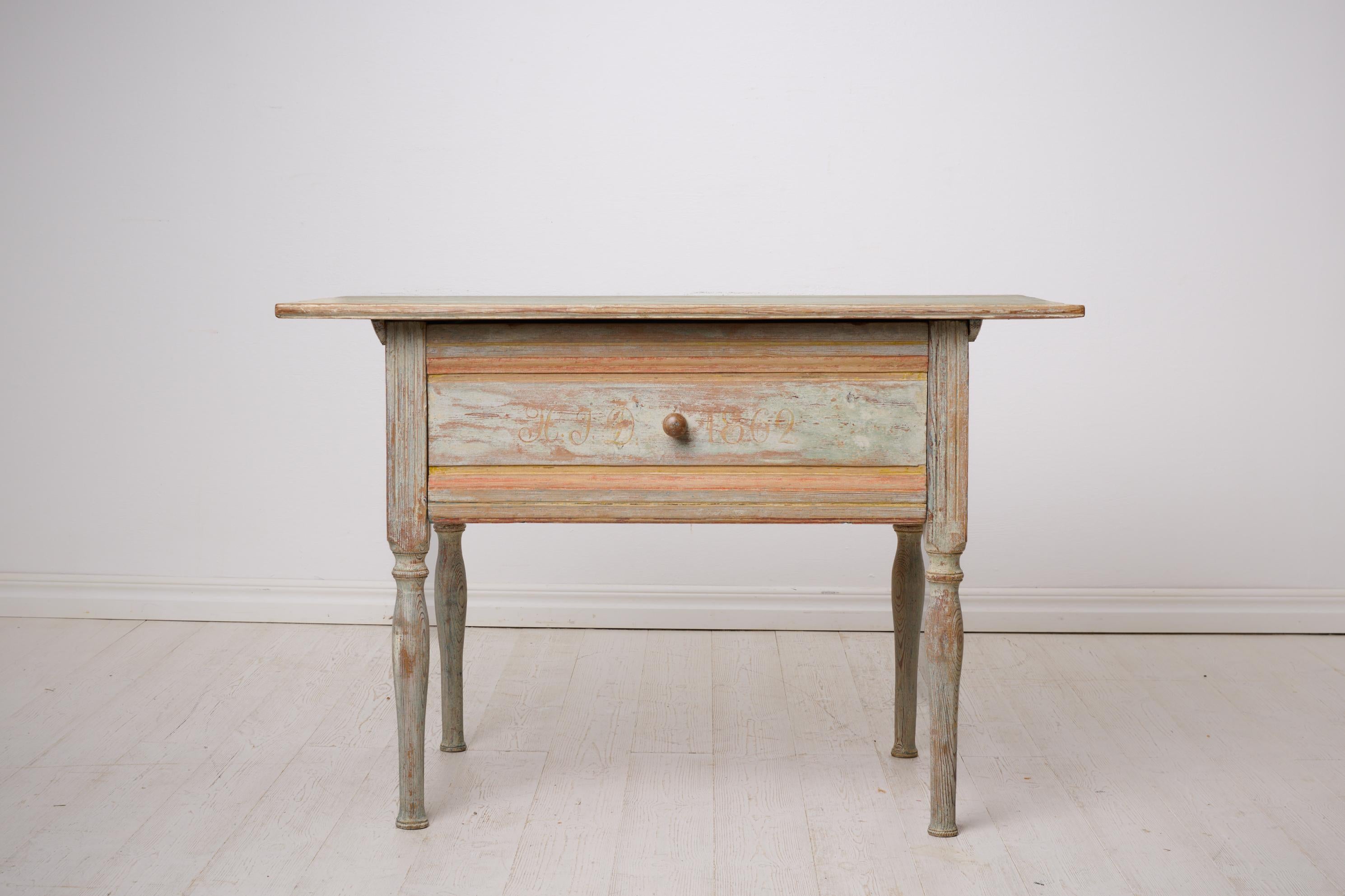 Antique folk art table from Sweden dated 1862. Made by hand in solid pine with the original first layer of paint. The table is rectangular with a large drawer and painted initials and a date on the drawer. Healthy and stable frame.